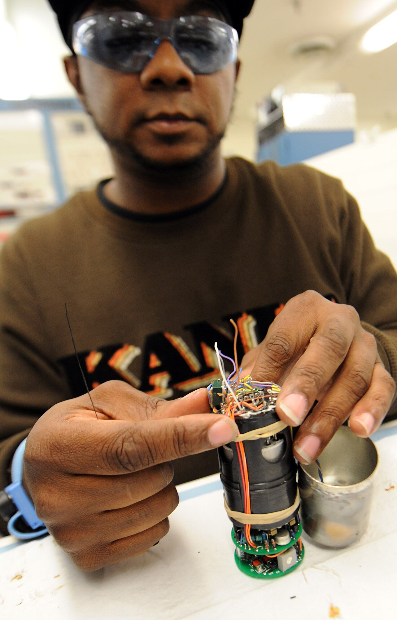 Kelvin Bryant, 566th Electronics Maintenance Squadron electronics worker, secures the wiring of a TRU-2 sub-assembly prior to performing the delicate task of connecting them to the electronic components of the assembly. . (U.S. Air Force photo by Tommie Horton)