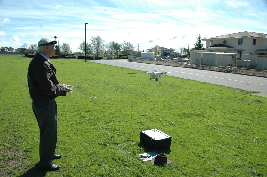 Gil Gardner, 60th Medical Group medical multimedia manager, works the remote controls commanding the flight of the DJI Phantom 1 aerial multirotor platform with GoPro H3 sports camera. (U.S. Air Force photo / Jim Spellman)