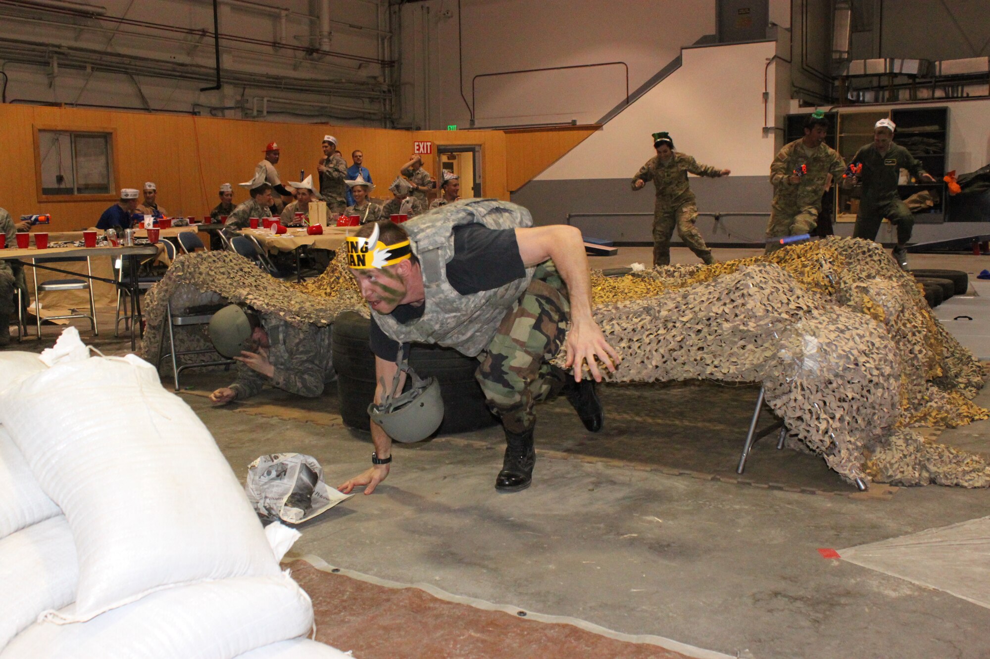 PETERSON AIR FORCE BASE, Colo. – Capt. Dustin O’Donnell, 2nd Space Operations Squadron, sprints through an obstacle course during the Rocky Mountain Company Grade Officers Council combat dining in March 8 in hangar 133. About 125 CGOs attended the event. The guest speaker was Maj. Gen. Martin Whelan, Headquarters Air Force Space Command director of Requirements, who offered the CGOs career advice and other words of wisdom. Other activities included nerf gun wars, crud, giant jenga and more. (U.S. Air Force photo/2nd Lt. Sarah Auer)