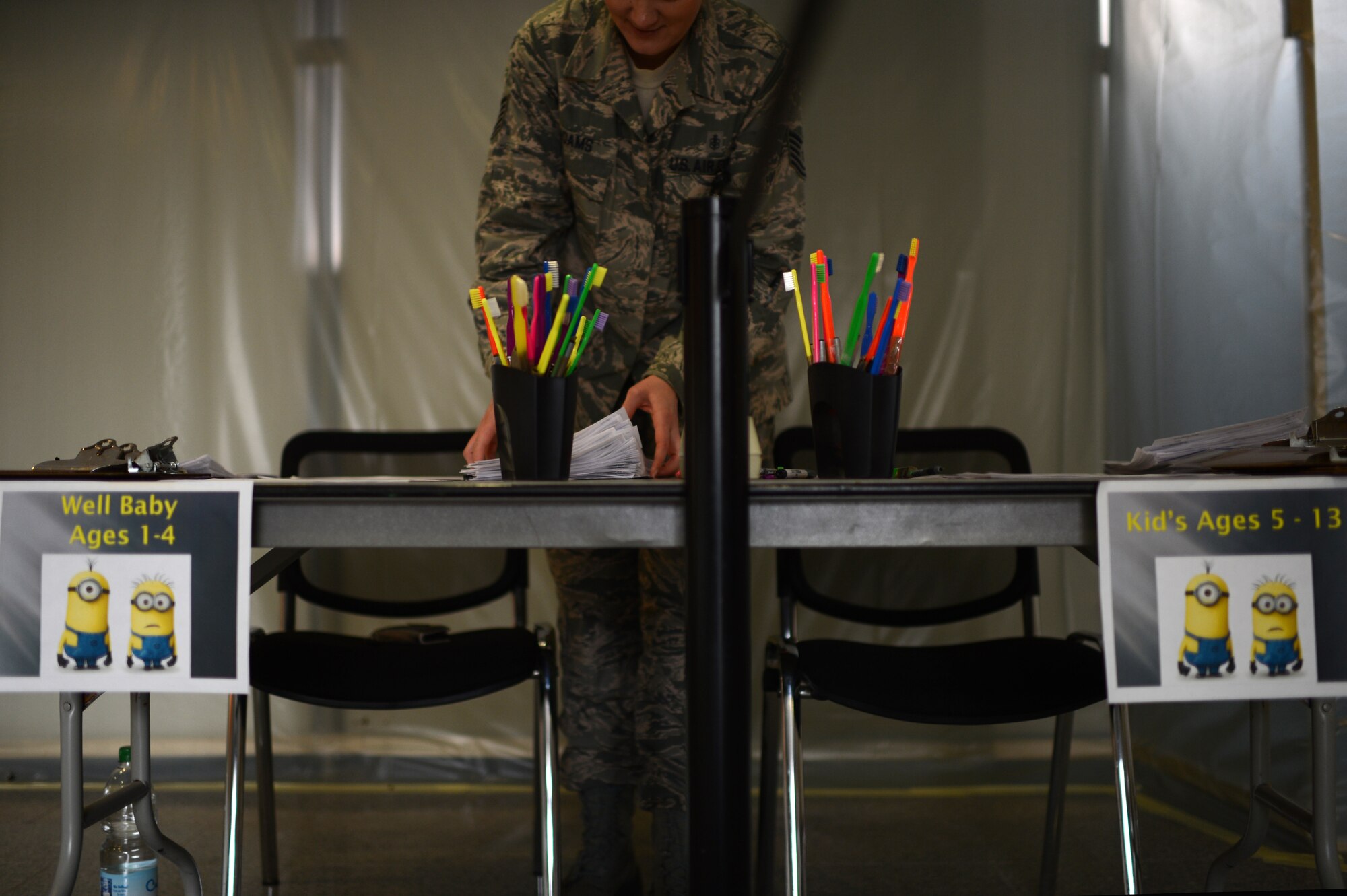 U.S. Air Force Tech. Sgt. Jolene Adams, 52nd Dental Squadron NCO in charge of dental records from Thousand Oaks, Calif., organizes a reception desk during a walk-in clinic for children at Spangdahlem Air Base, Germany, March 21, 2014. The 52nd DS staff organize the walk-in event semi-annually to offer an easy access to dental education, cleaning and exams for Spangdahlem and geographically separated Airmen and families. (U.S. Air Force photo by Senior Airman Gustavo Castillo/Released)