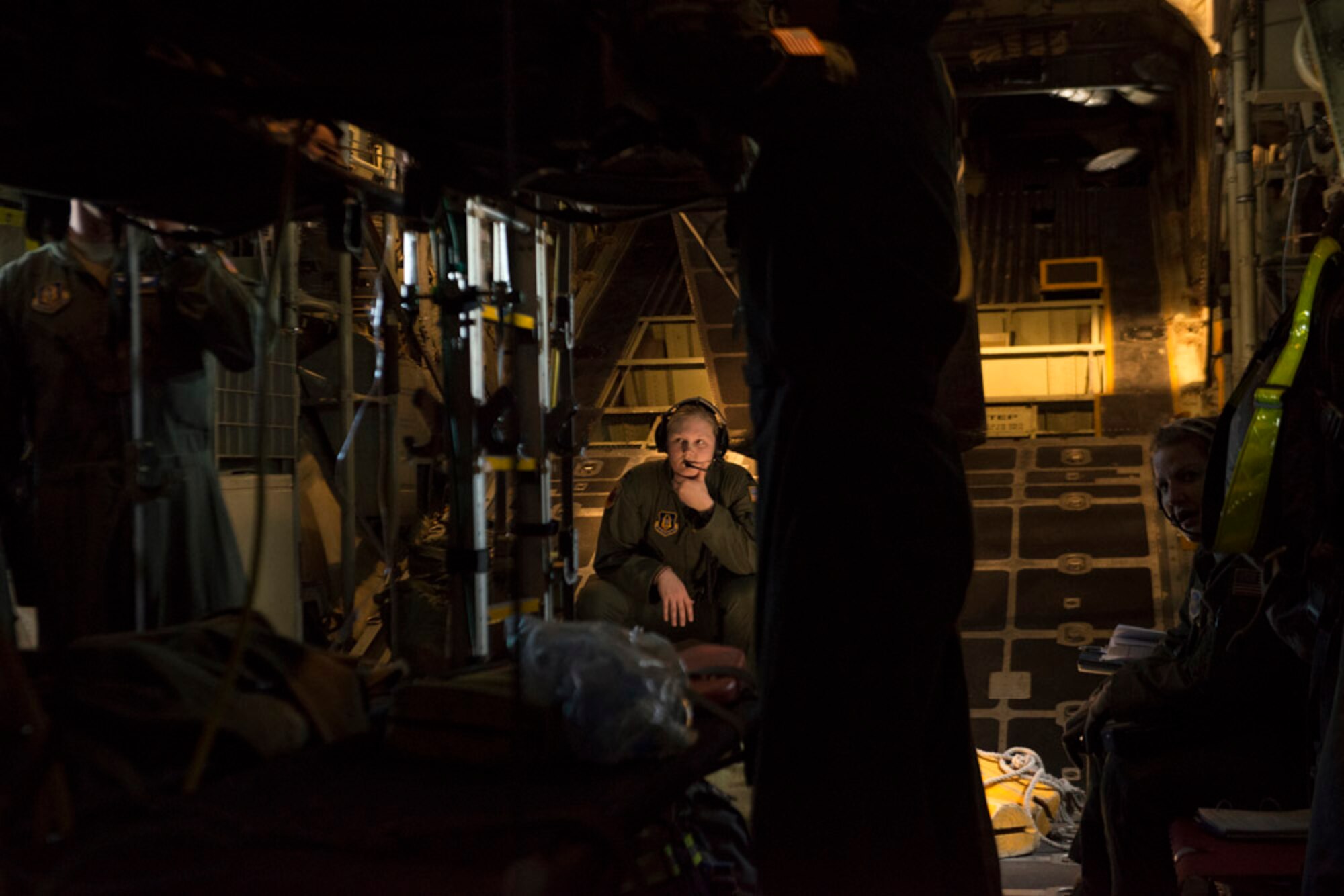 Captain Mackenzie Johnson, a Flight Nurse with the 36th Aeromedical Evacuation Squadron, monitors "patents" in a C-130H during a training exercise. . (Photo by Lewis Perkins/Paraglide)