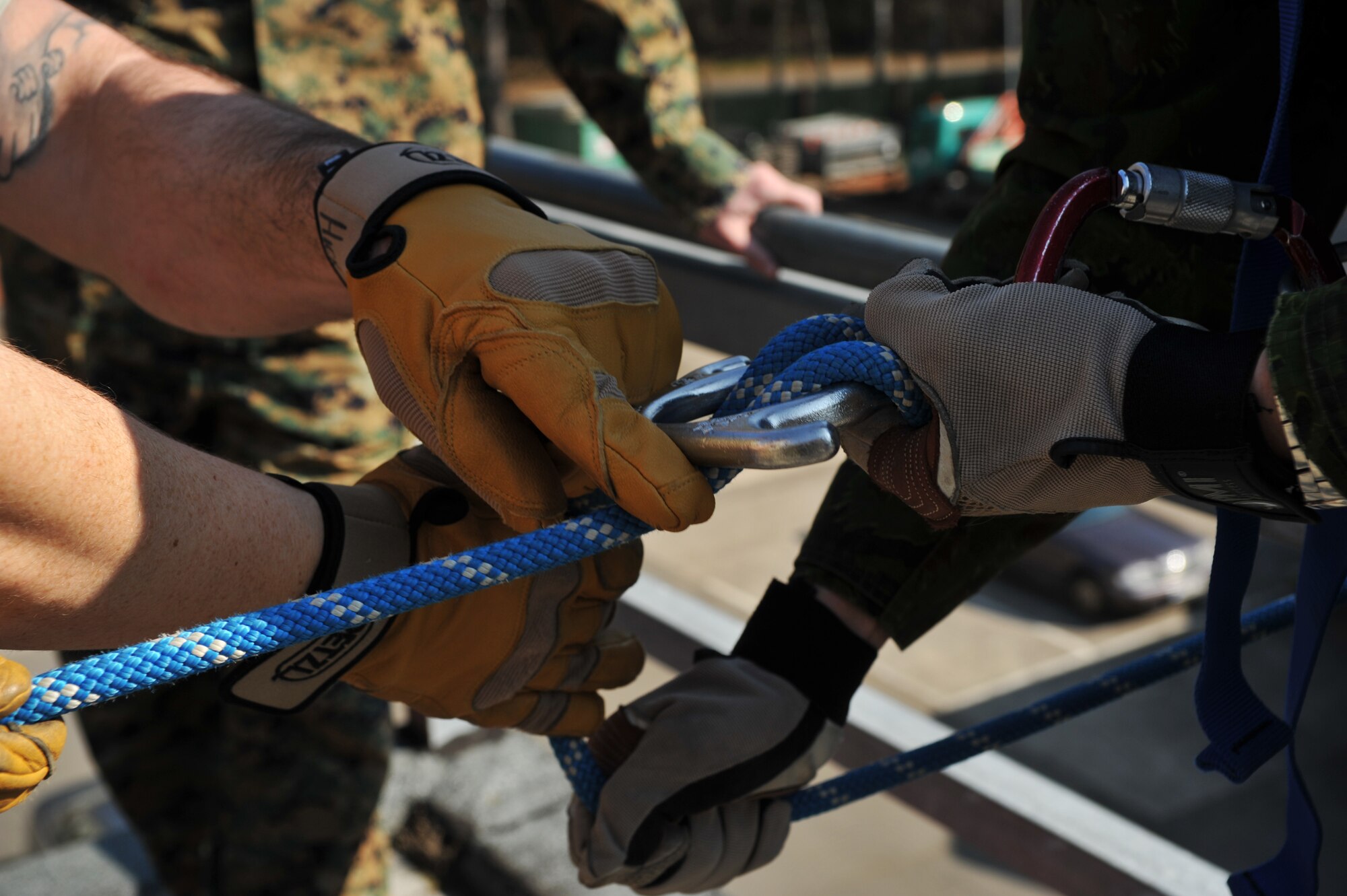 Airmen from the 435th Construction and Training Squadron assist a Lithuanian military member with rope fundamentals during the rescue portion of the Firefighters Fundamentals Course, March 13, 2014, at Ramstein Air Base, Germany. The course consisted of hands-on simulations and classroom portions allowing service members to learn about different fire rescue techniques. (U.S. Air Force photo/Senior Airman Hailey Haux)