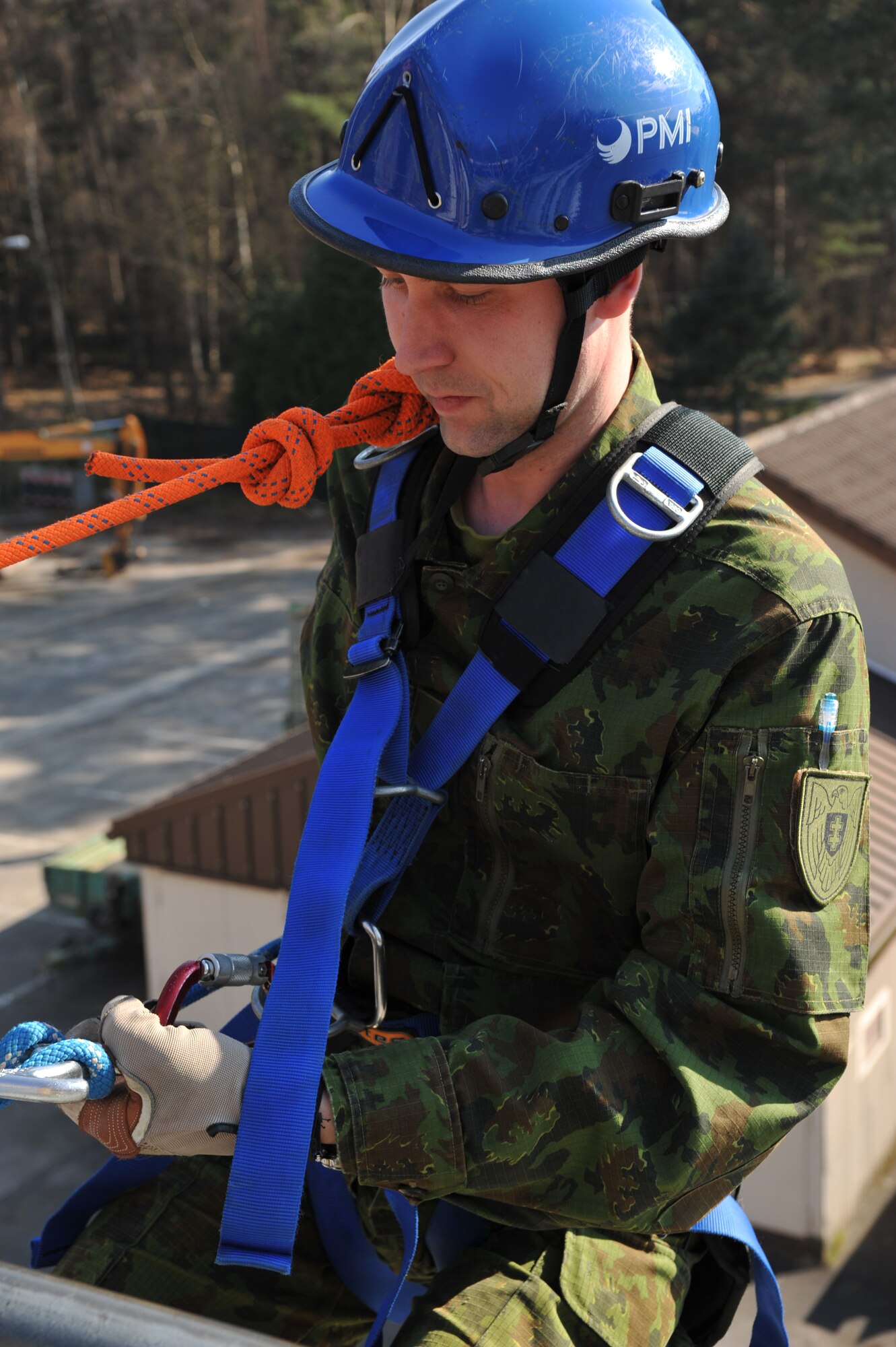 A Lithuanian military member prepares to repel down a building during the rescue portion of the Firefighters Fundamentals Course, March 13, 2014, at Ramstein Air Base, Germany. The course consisted of hands-on simulations and classroom portions allowing service members to learn about different fire rescue techniques. (U.S. Air Force photo/Senior Airman Hailey Haux)