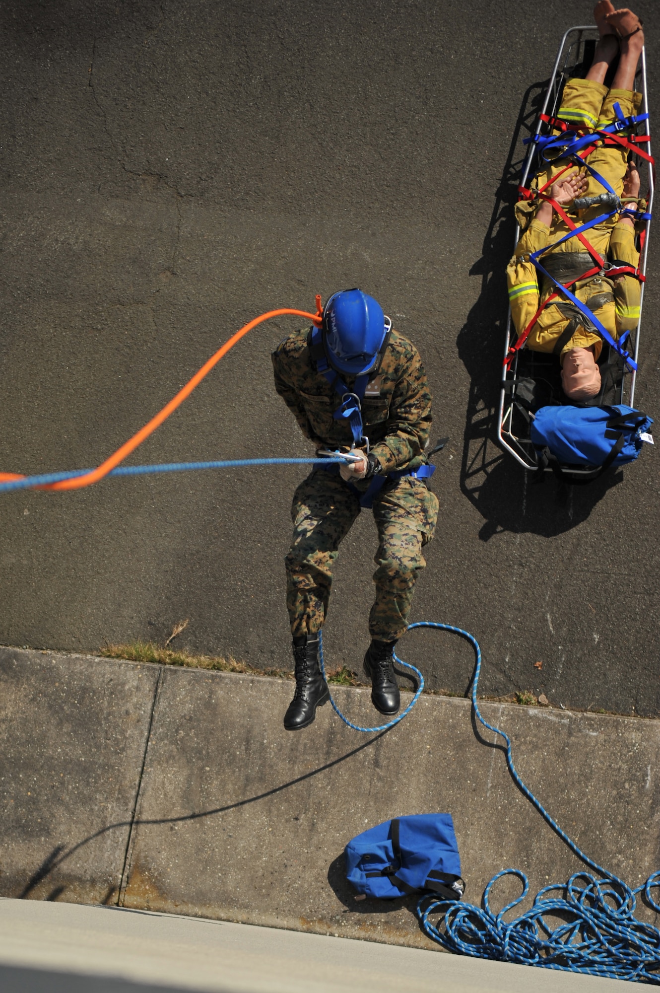 A Bosnian military member repels down a building during the rescue portion of the Firefighters Fundamentals Course, March 13, 2014, at Ramstein Air Base, Germany. The course consisted of hands-on simulations and classroom portions allowing service members to learn about different fire rescue techniques. (U.S. Air Force photo/Senior Airman Hailey Haux)