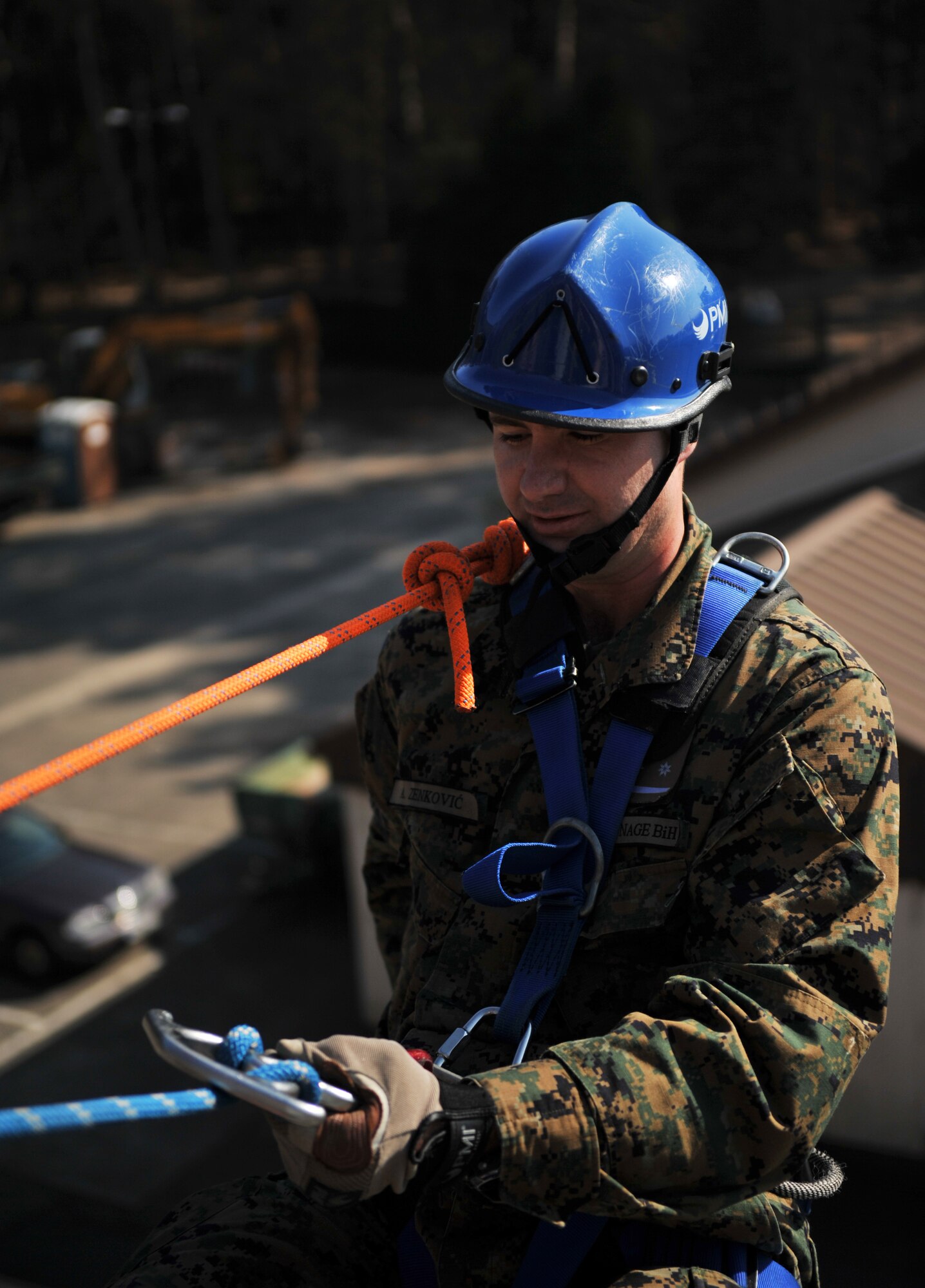 A Bosnian military member prepares to repel down a building during the rescue portion of the Firefighters Fundamentals Course, March 13, 2014, at Ramstein Air Base, Germany. The course consisted of hands-on simulations and classroom portions allowing service members to learn about different fire rescue techniques. (U.S. Air Force photo/Senior Airman Hailey Haux)