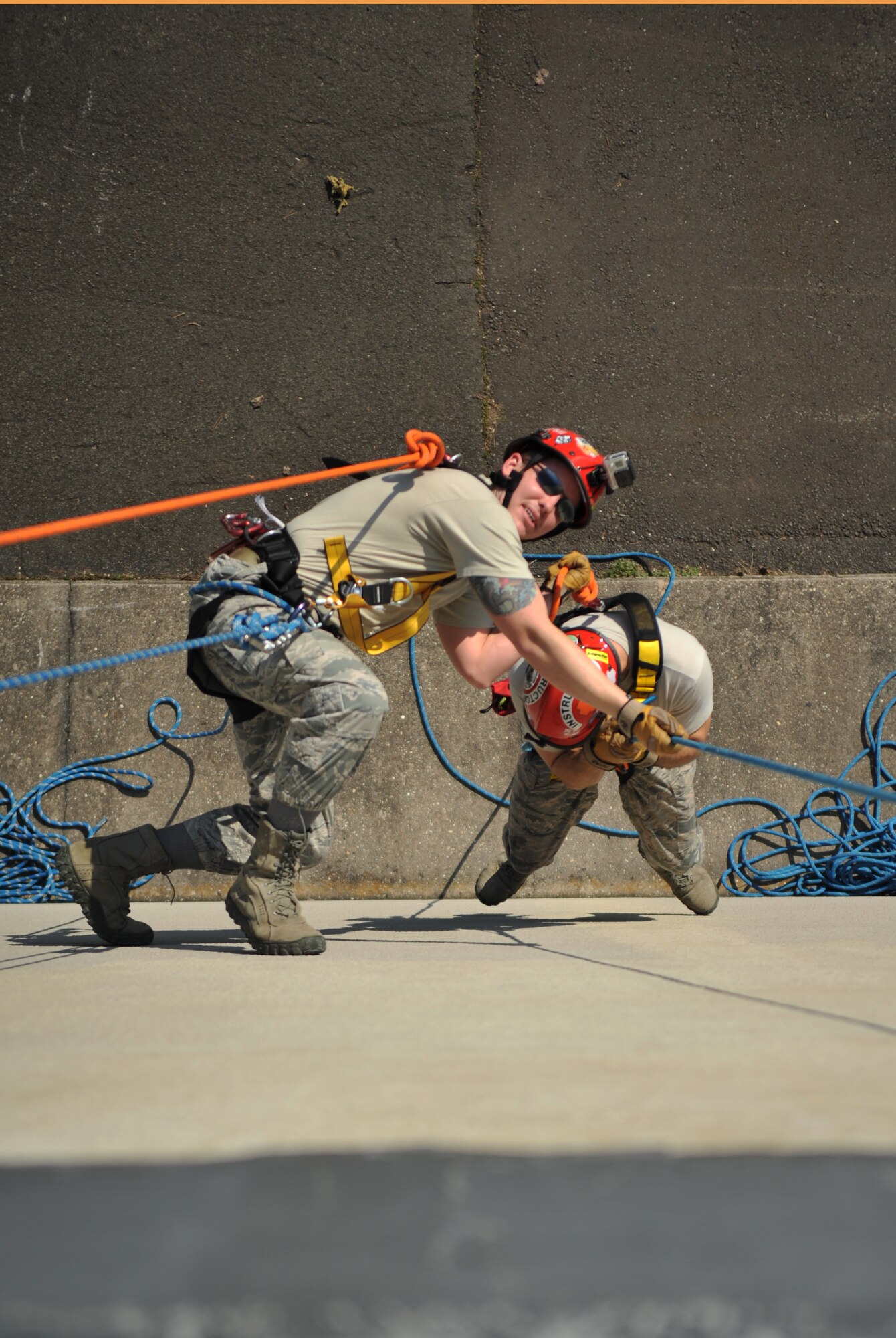 Airmen from the 435th Construction and Training Squadron show Lithuanian and Bosnian military members how to rescue a victim from a tall building during the Firefighters Fundamentals Course, March 13, 2014, at Ramstein Air Base, Germany. The course consisted of hands-on simulations and classroom portions allowing service members to learn about different fire rescue techniques. (U.S. Air Force photo/Senior Airman Hailey Haux)