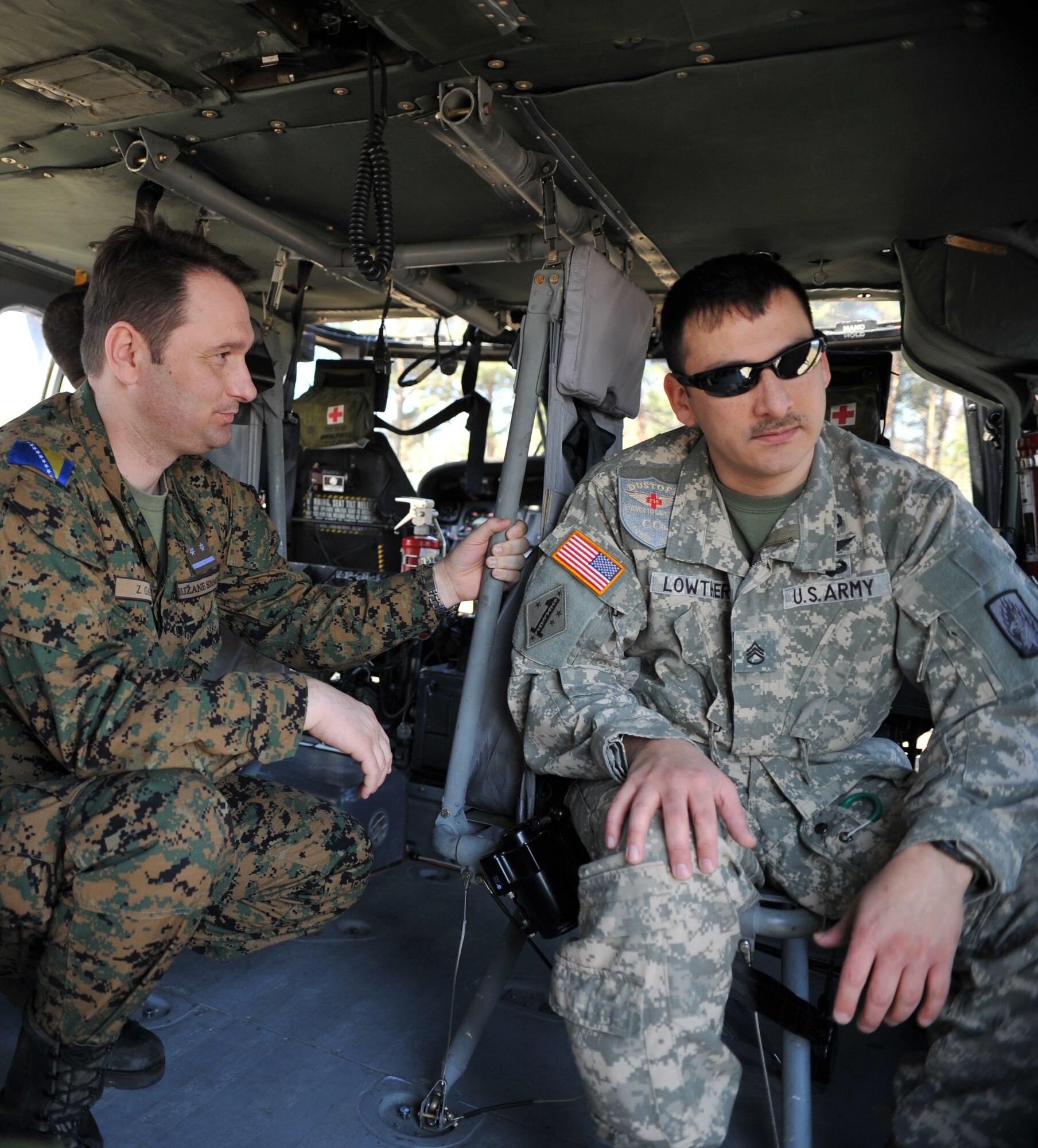 Lithuanian and Bosnian military members receive a tour of a rotary wing aircraft as part of the Firefighters Fundamentals Course, March 12, 2014, at Landstuhl Regional Medical Center, Germany. The course consisted of hands-on simulations and classroom portions allowing service members to learn about different fire rescue techniques. (U.S. Air Force photo/Senior Airman Hailey Haux)