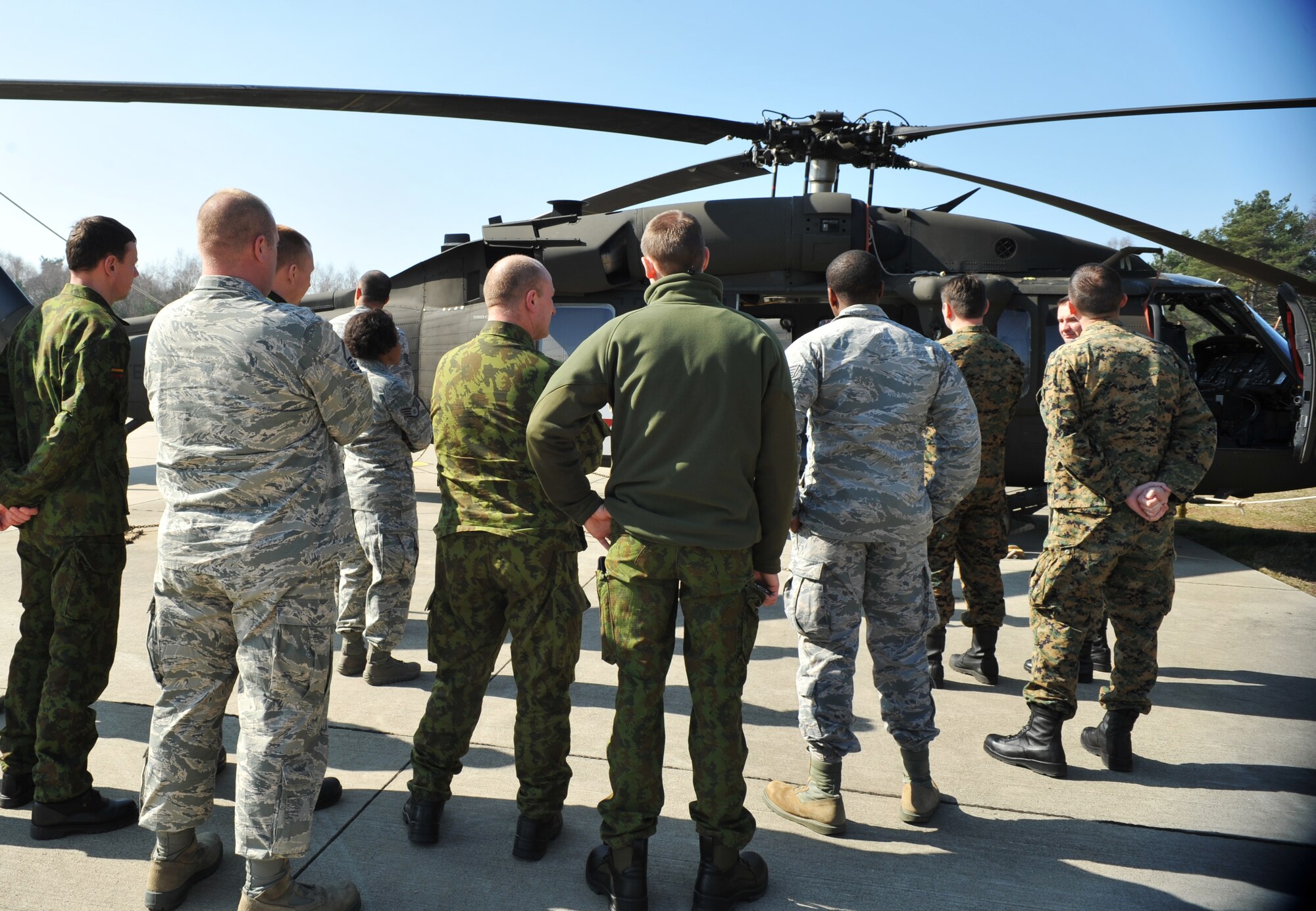 Lithuanian and Bosnian military members take a tour of a rotary wing aircraft as part of the Firefighters Fundamentals Course, March 12, 2014, at Landstuhl Regional Medical Center, Germany. The course consisted of hands-on simulations and classroom portions allowing service members to learn about different fire rescue techniques. (U.S. Air Force photo/Senior Airman Hailey Haux)