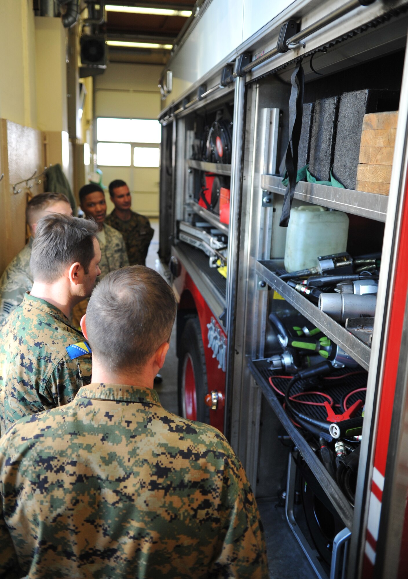 Bosnian military members take a tour of a fire house as part of the Firefighters Fundamentals Course, March 12, 2014, at Ramstein Air Base, Germany. The course consisted of hands-on simulations and classroom portions allowing service members to learn about different fire rescue techniques. (U.S. Air Force photo/Senior Airman Hailey Haux)