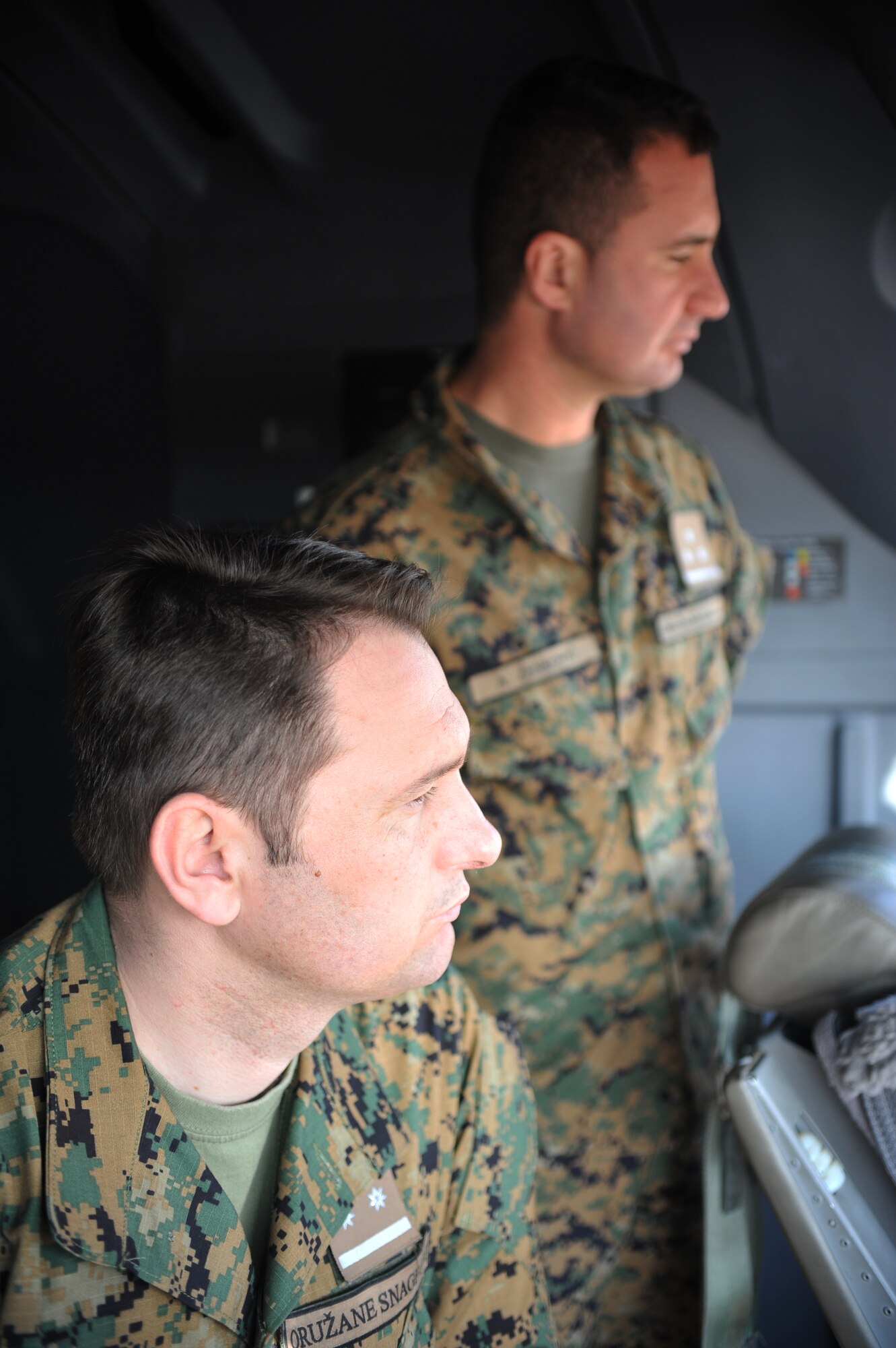 Two Bosnian military members take a tour of a C-130J Super Hercules during the Firefighters Fundamentals Course, March 11, 2014, at Ramstein Air Base, Germany. The course consisted of hands-on simulations and classroom portions allowing service members to learn about different fire rescue techniques. (U.S. Air Force photo/Senior Airman Hailey Haux)