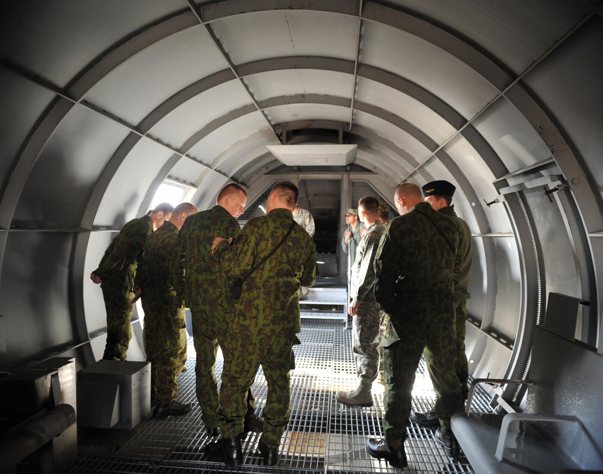 Lithuanian and Bosnian military members take a tour of a training aircraft during the Firefighters Fundamentals Course, March 11, 2014, at Ramstein Air Base, Germany. The course consisted of hands-on simulations and classroom portions allowing service members to learn about different fire rescue techniques. (U.S. Air Force photo/Senior Airman Hailey Haux)