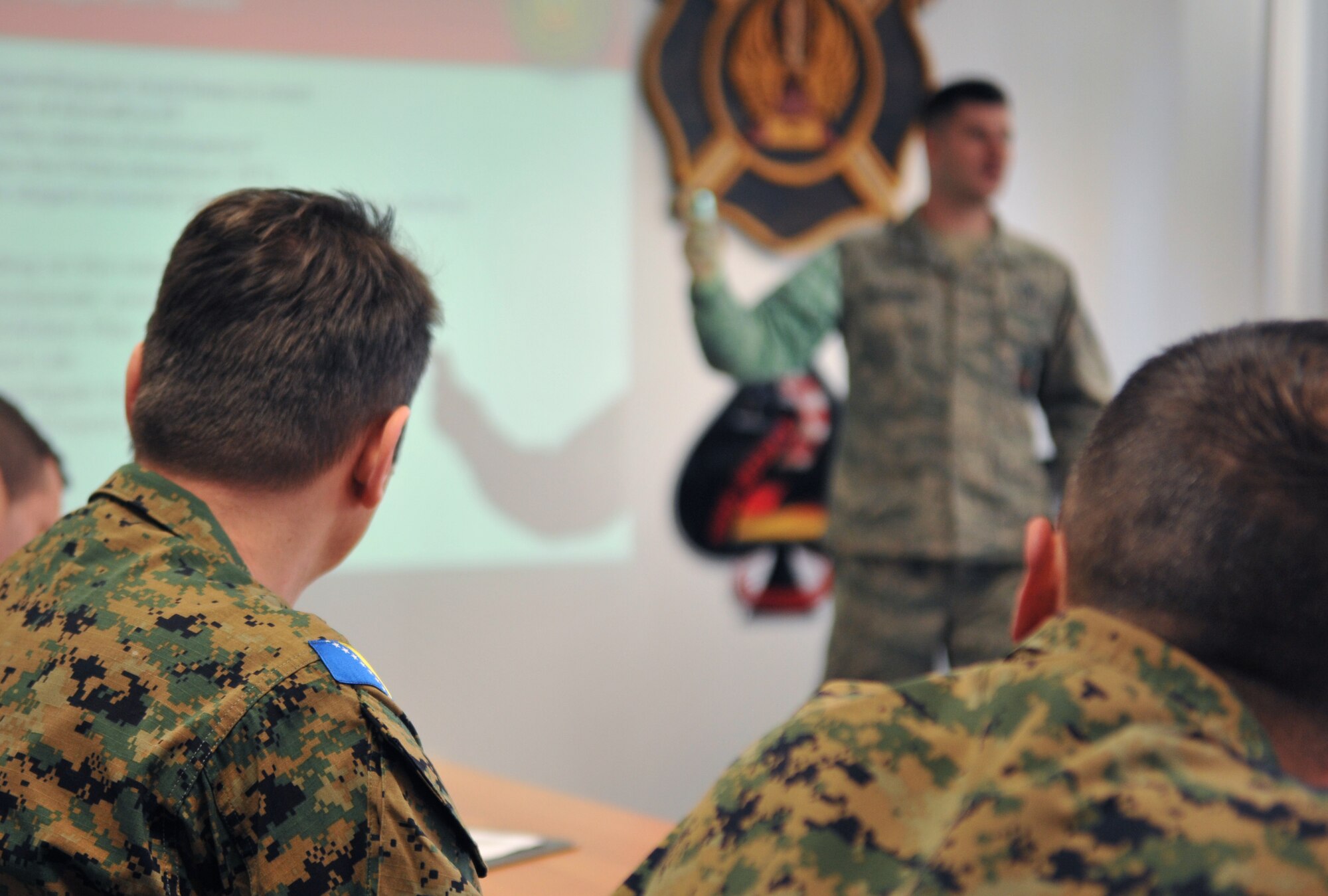 A Bosnian military member listens to Staff Sgt. Justin Hrusovsky, 435th Construction and Training Squadron fire and rescue contingency instructor, teach about different fire techniques during the Firefighters Fundamentals Course, March 11, 2014, at Ramstein Air Base, Germany. The course consisted of hands-on simulations and classroom portions allowing service members to learn about different fire rescue techniques. (U.S. Air Force photo/Senior Airman Hailey Haux)