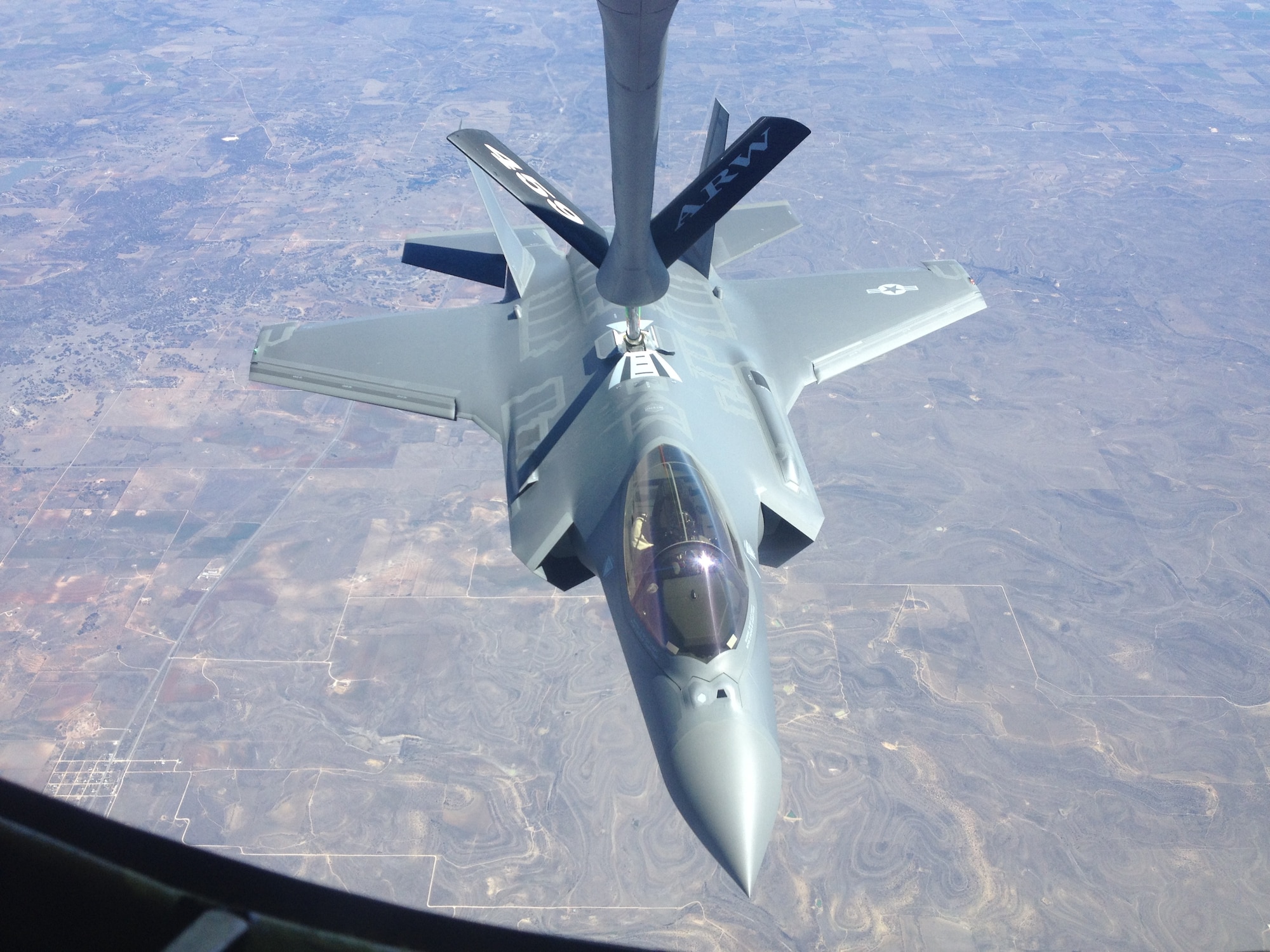 An F-35 Lighting II fighter jet from the 33rd Fighter Wing, Eglin Air Force Base, Fla., gets refueled by a KC-135 Stratotanker from the 459th Air Refueling Wing, Joint Base Andrews, Md., over the plains of Texas, March 12, 2014. The tanker met with the fighter jet at 27,000 feet in the air for an aerial refueling mission. (U.S. Air Force photo/ Staff Sgt. Katie Spencer)