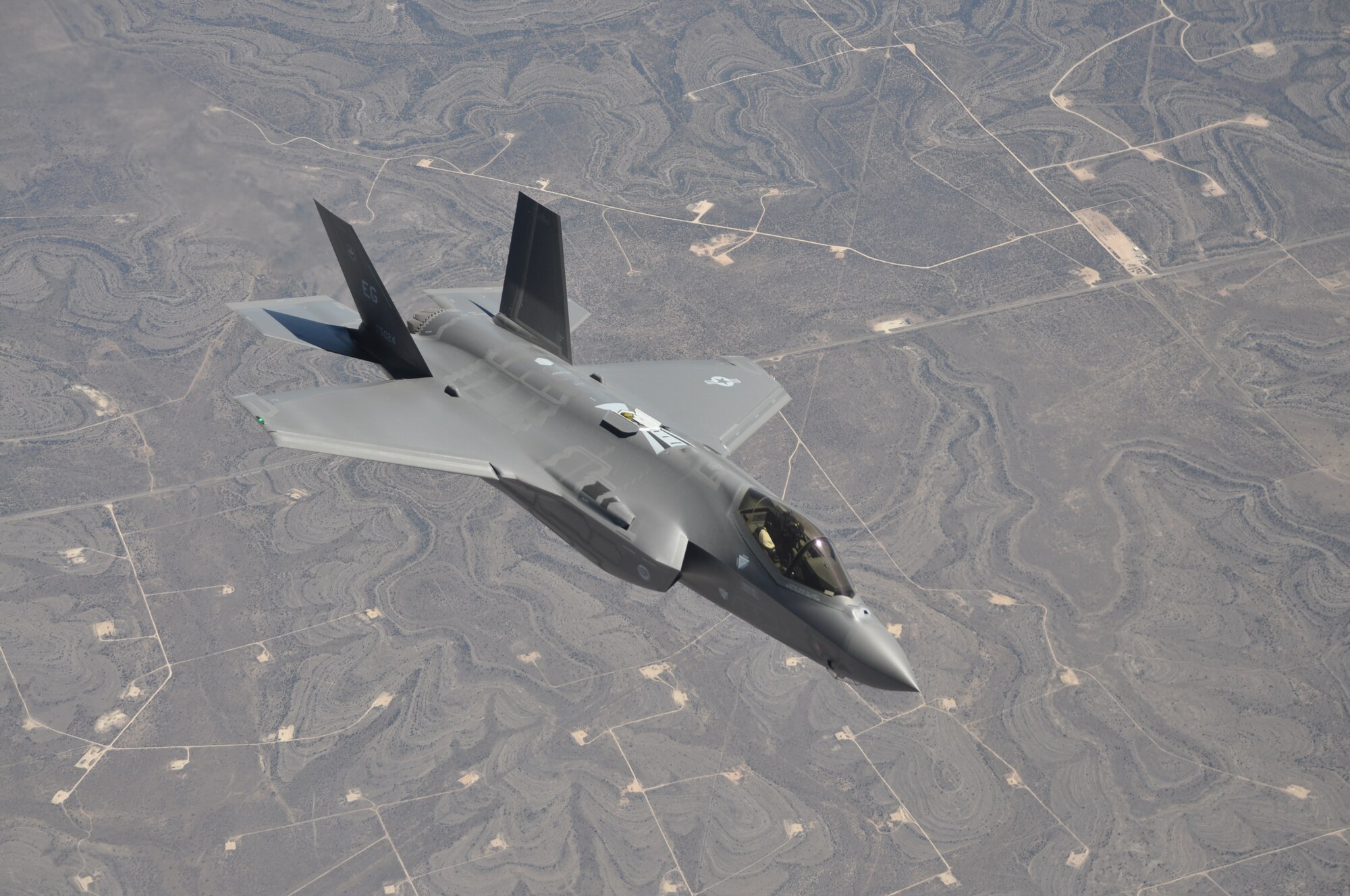 An F-35 Lighting II fighter jet from the 33rd Fighter Wing, Eglin Air Force Base, Fla., flies over the plains of Texas, March 12, 2014. The fighter jet was  part of an aerial refueling mission with a KC-135 Stratotanker from the 459th Air Refueling Wing, Joint Base Andrews, Md. (U.S. Air Force photo/ Staff Sgt. Katie Spencer)