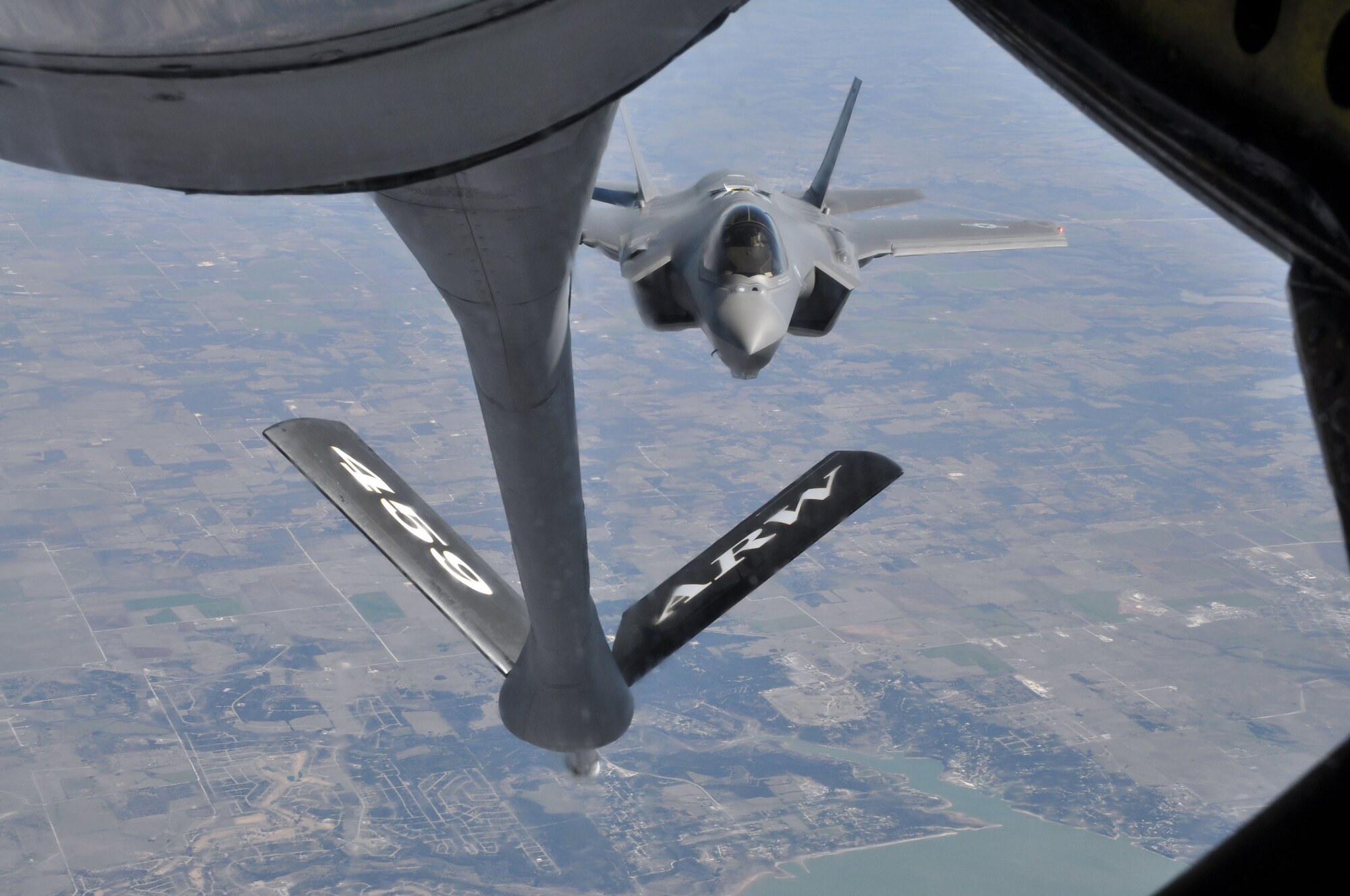 An F-35 Lighting II fighter jet from the 33rd Fighter Wing, Eglin Air Force Base, Fla., approaches the boom of a KC-135 Stratotanker from the 459th Air Refueling Wing, Joint Base Andrews, Md., over the plains of Texas, March 12, 2014. The tanker met with the fighter jet at 27,000 feet in the air for an aerial refueling mission. (U.S. Air Force photo/ Staff Sgt. Katie Spencer)