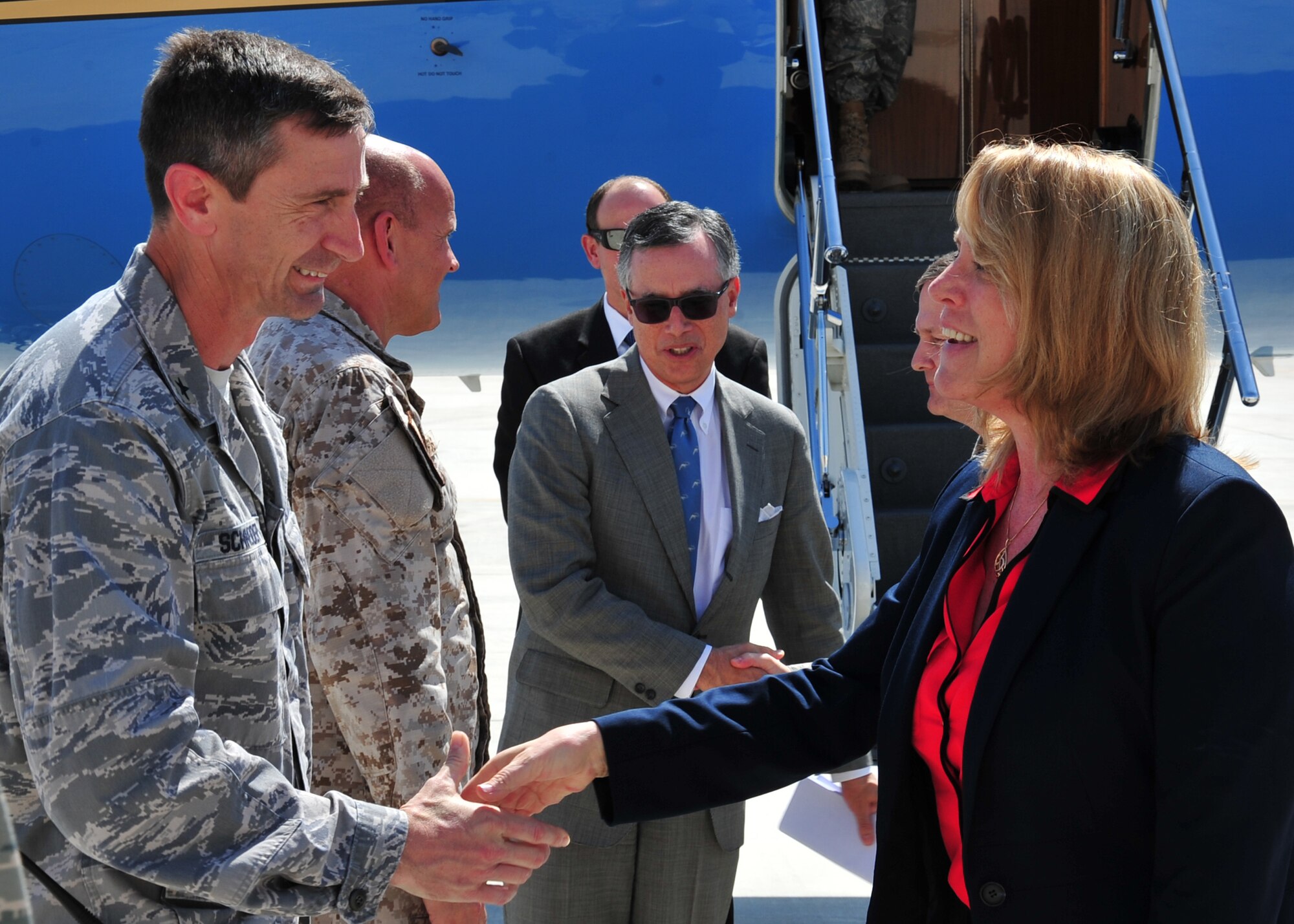 Brig. Gen. Kevin Schneider, 380th Air Expeditionary Wing commander, greets Secretary of the Air Force Deborah Lee James at an undisclosed location  in Southwest Asia, March 19, 2014. The secretary visited the base to learn more about the mission and role of the 380 AEW and to meet with Airmen. (U.S. Air Force photo by Staff Sgt. Michael Means/Released)
