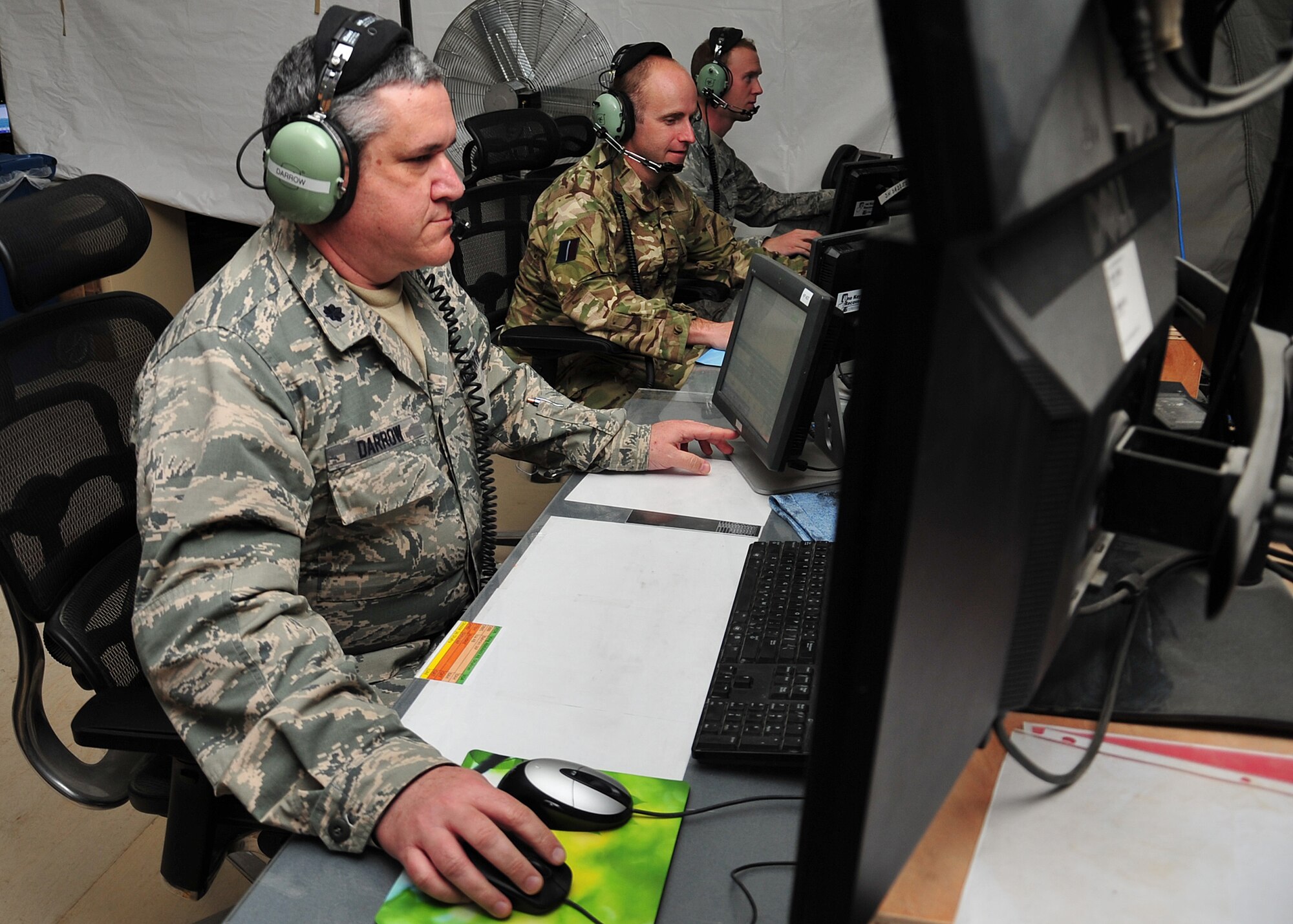 Lt. Col. Christopher Darrow, 727th Expeditionary Air Control Squadron director of operations, is on position at the Battlespace Command and Control Center at an undisclosed location in Southwest Asia, March 20, 2014. (U.S. Air Force photo by Staff Sgt. Michael Means/Released)