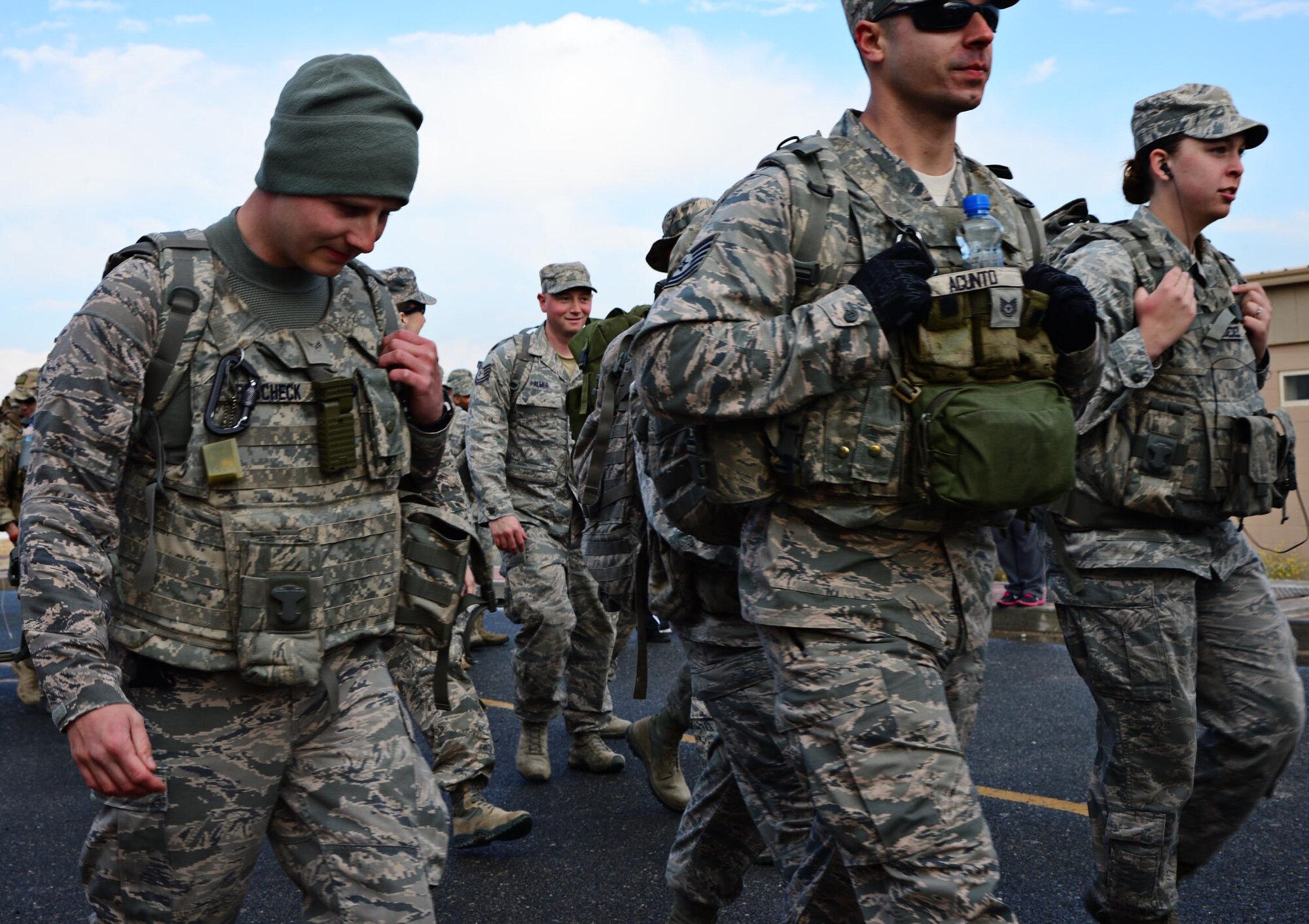 Fire Dogs and Defenders of the 386th Air Expeditionary Wing participate in a memorial ruck march during the “Battle of the Badges”, to commemorate their fallen comrades, build camaraderie throughout the units and to celebrate their occupation. (U.S. Air Force photo by Senior Airman Desiree W. Moye)