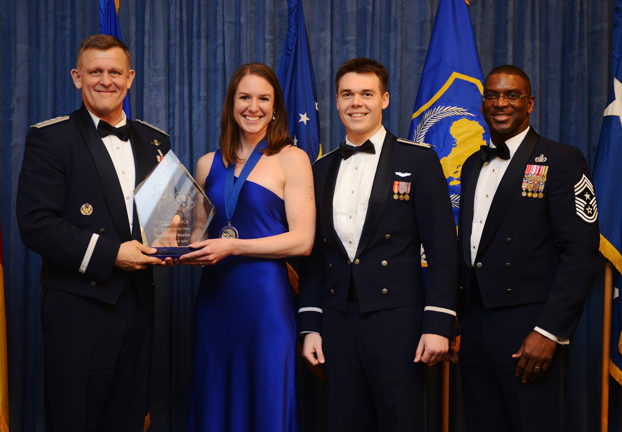 Brittany Martin, 492nd Fighter Squadron key spouse, receives her U.S. Air Forces in Europe and Air Forces Africa Honor Guard Member of the Year award from Gen. Frank Gorenc, USAFE-AFAFRICA commander and Chief Master Sgt. James E. Davis, USAFE-AFAFRICA command chief, during an annual awards ceremony at Ramstein Air Base Germany March 20, 2014. The Airmen competed within their units, then at the wing level and have now been named the best in USAFE-AFAFRICA. They will go on to compete at the Air Force level for the coveted Outstanding Airmen of the Year award which will be announced later this year. (U.S. Air Force photo/ Staff Sgt. Ryan Crane)