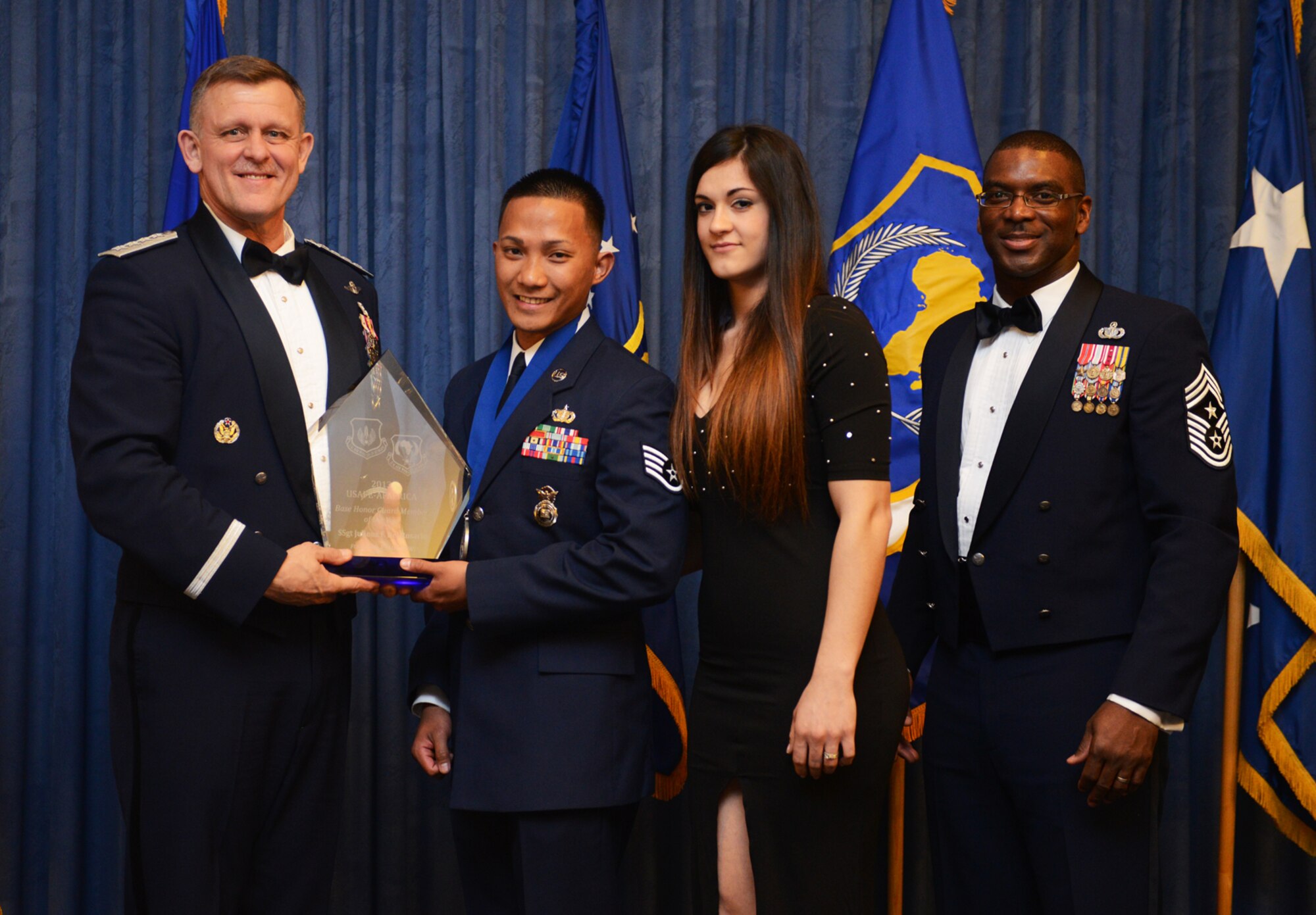 Staff Sgt. Julious Del Rosario, 52nd Security Forces Squadron patrolman, receives his U.S. Air Forces in Europe and Air Forces Africa Honor Guard Member of the Year award from Gen. Frank Gorenc, USAFE-AFAFRICA commander and Chief Master Sgt. James E. Davis, USAFE-AFAFRICA command chief, during an annual awards ceremony at Ramstein Air Base Germany March 20, 2014. The Airmen competed within their units, then at the wing level and have now been named the best in USAFE-AFAFRICA. They will go on to compete at the Air Force level for the coveted Outstanding Airmen of the Year award which will be announced later this year. (U.S. Air Force photo/ Staff Sgt. Ryan Crane)