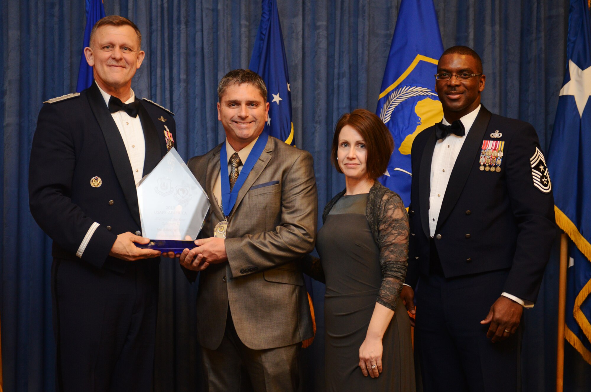 Allen Fry, 48th Civil Engineer Squadron installation management flight chief, receives his U.S. Air Forces in Europe and Air Forces Africa Civilian Category II of the Year award from Gen. Frank Gorenc, USAFE-AFAFRICA commander and Chief Master Sgt. James E. Davis, USAFE-AFAFRICA command chief, during an annual awards ceremony at Ramstein Air Base Germany March 20, 2014. The Airmen competed within their units, then at the wing level and have now been named the best in USAFE-AFAFRICA. They will go on to compete at the Air Force level for the coveted Outstanding Airmen of the Year award which will be announced later this year. (U.S. Air Force photo/ Staff Sgt. Ryan Crane)