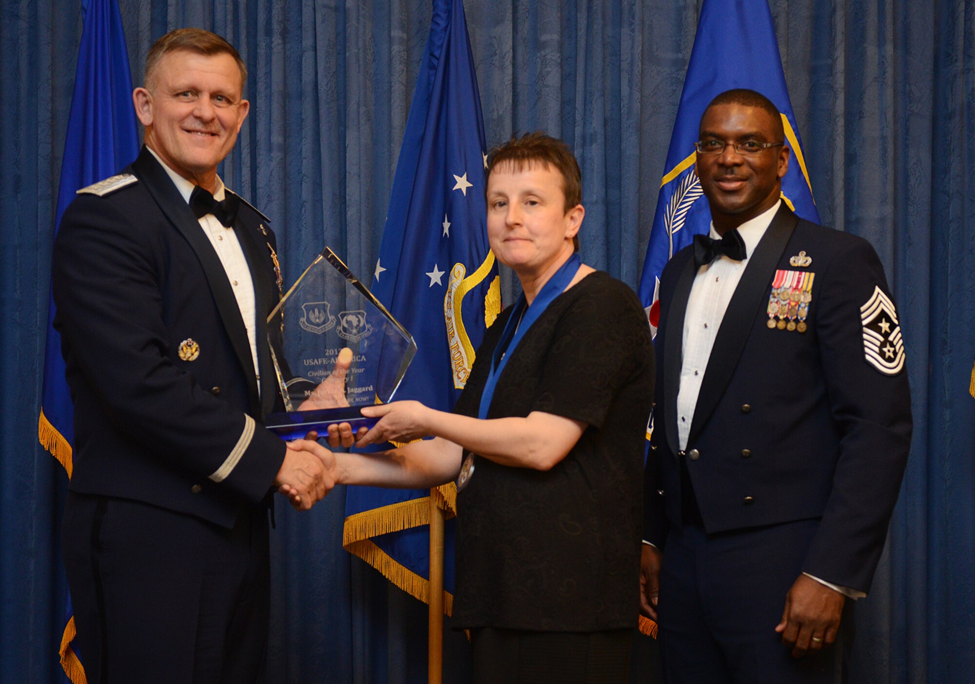 Jackie Jaggard, 48th Logistics Readiness Squadron supply inspector, receives her U.S. Air Forces in Europe and Air Forces Africa Civilian Category I of the Year award from Gen. Frank Gorenc, USAFE-AFAFRICA commander and Chief Master Sgt. James E. Davis, USAFE-AFAFRICA command chief, during an annual awards ceremony at Ramstein Air Base Germany March 20, 2014. The Airmen competed within their units, then at the wing level and have now been named the best in USAFE-AFAFRICA. They will go on to compete at the Air Force level for the coveted Outstanding Airmen of the Year award which will be announced later this year.  (U.S. Air Force photo/ Staff Sgt. Ryan Crane)