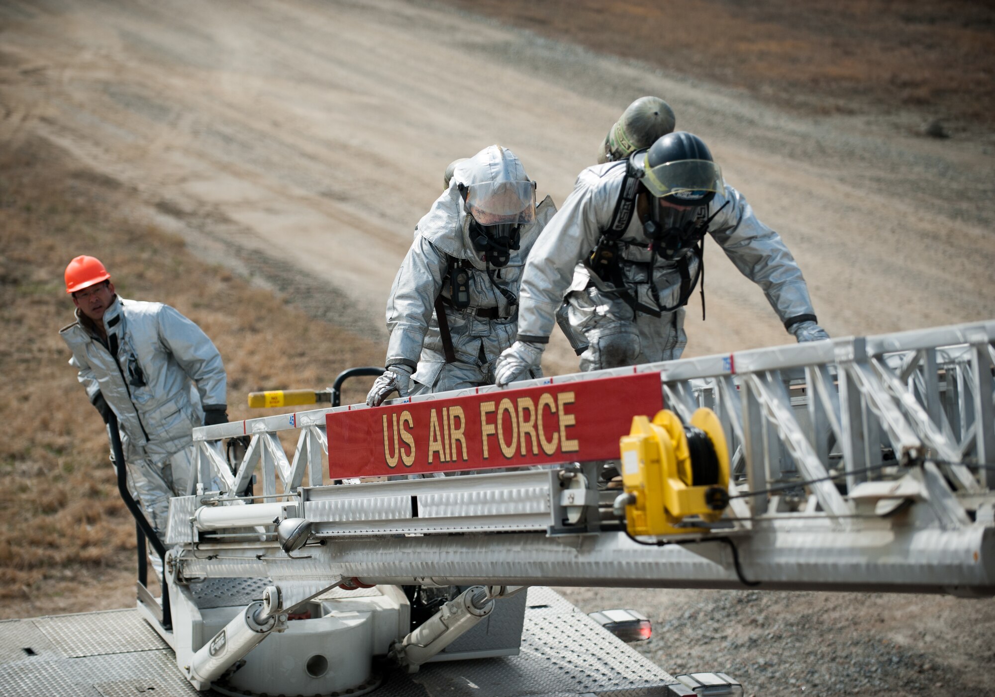 Firefighters from the 8th Civil Engineer Squadron fire department mount a turntable to enter a building during an exercise at Kunsan Air Base, Republic of Korea, Mar. 18, 2014. The 8th CES fire department conducted classroom and live-fire training with firefighters from Marine Wing Support Squadron 172 and the Republic of Korea air force 38th Fighter Group fire department to enhance teamwork between fire departments. (U.S. Air Force photo by Staff Sgt. Clayton Lenhardt/Released)