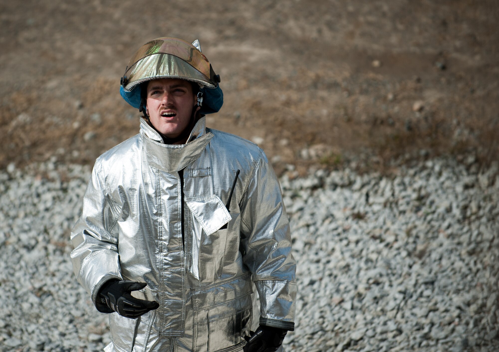 Senior Airman John Sexton, 8th Civil Engineer Squadron firefighter, guides a turntable ladder into a building during a training scenario at Kunsan Air Base, Republic of Korea, Mar. 18, 2014. The 8th CES fire department conducted classroom and live-fire training with firefighters from Marine Wing Support Squadron 172 and the Republic of Korea air force 38th Fighter Group fire department to enhance teamwork between fire departments. (U.S. Air Force photo by Staff Sgt. Clayton Lenhardt/Released)