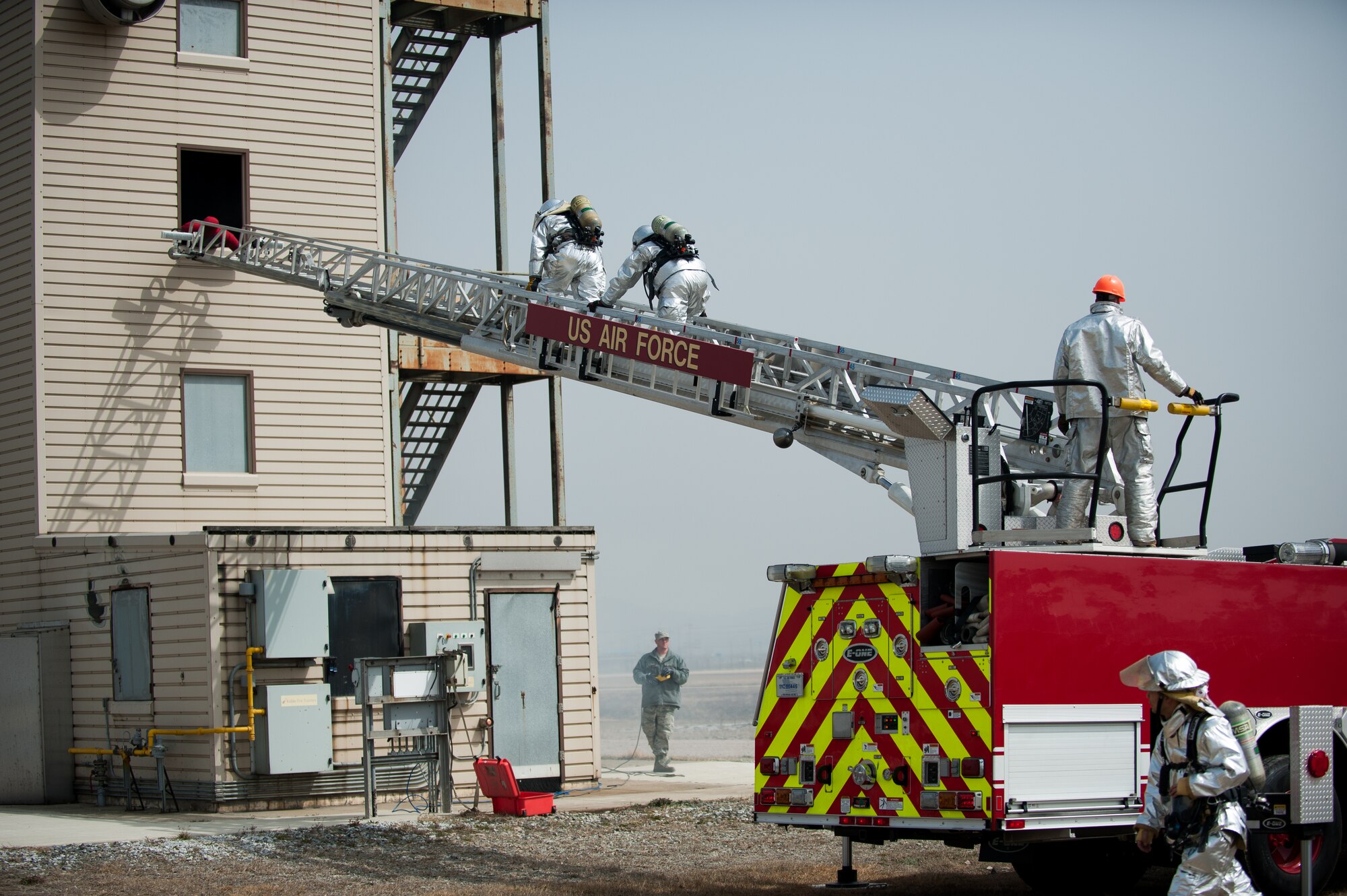 Firefighters from the 8th Civil Engineer Squadron fire department respond to a simulated fire at Kunsan Air Base, Republic of Korea, Mar. 18, 2014. The firefighters conducted classroom and live-fire training with firefighters from Marine Wing Support Squadron 172 and the Republic of Korea air force 38th Fighter Group fire department to enhance teamwork between fire departments.  (U.S. Air Force photo by Staff Sgt. Clayton Lenhardt/Released)