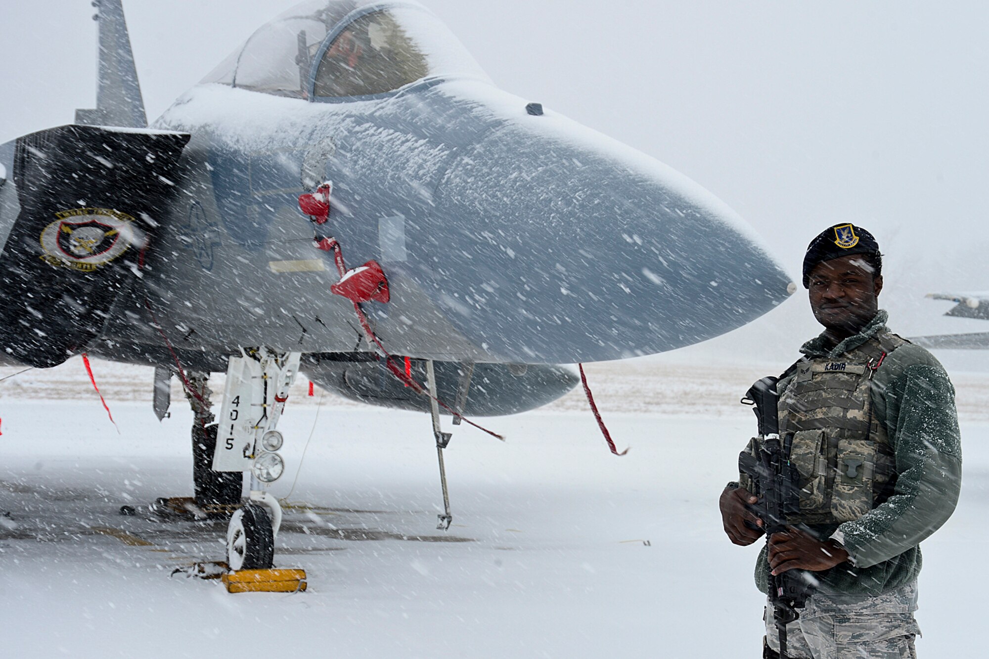 Senior Airman Yusif Kadir, 48th Air Expeditionary Group response force member, stands guard on the flightline at Šiauliai Air Base, Lithuania March 17, 2014. The 48th Fighter Wing at Royal Air Force Lakenheath, England, sent an additional six aircraft and more than 50 personnel, to augment the four aircraft and approximately 150 Airmen already supporting NATO's ongoing air policing mission, at the request of U.S. allies in the Baltics. (U.S. Air Force photo by Airman 1st Class Dana J. Butler)