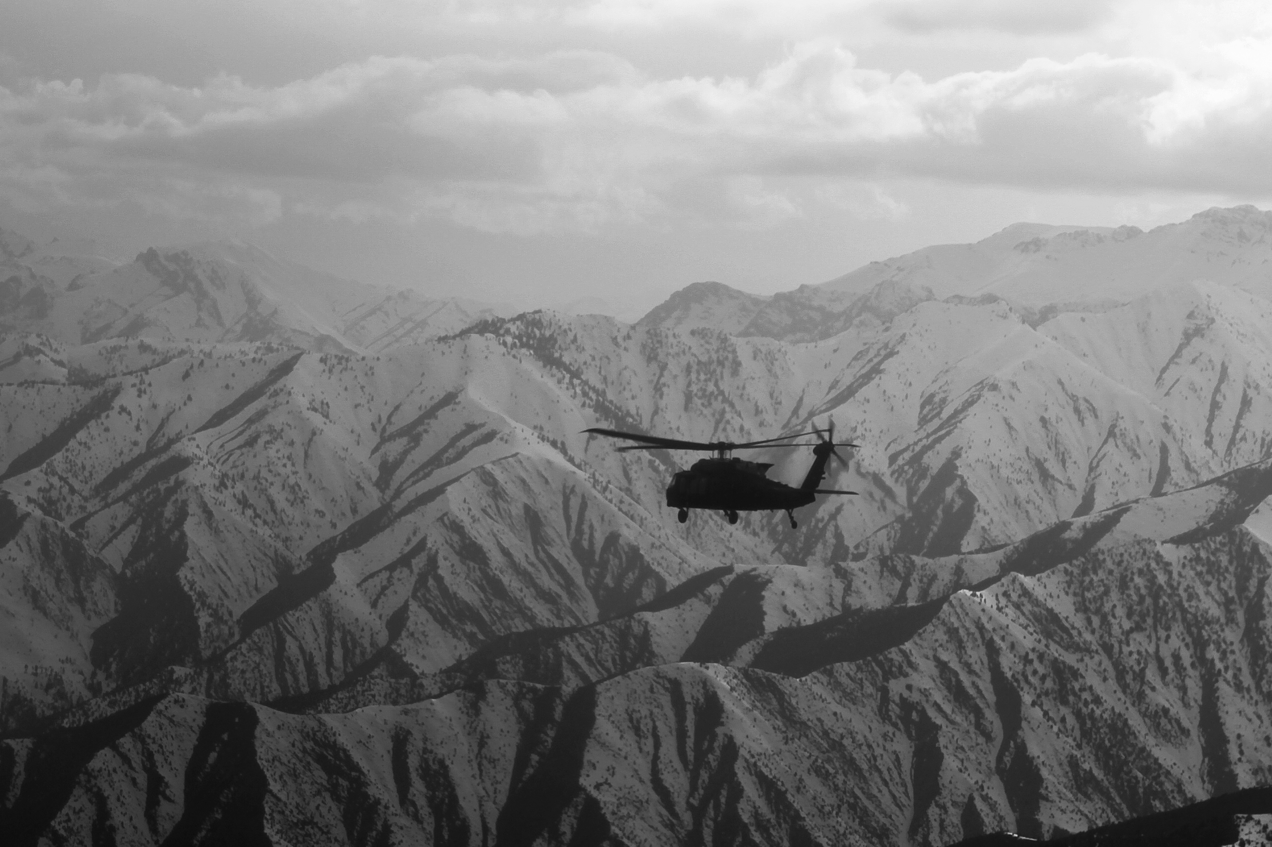 A Uh 60 Black Hawk Helicopter Flies Over The Mountains Of East Afghanistan March 12 2014