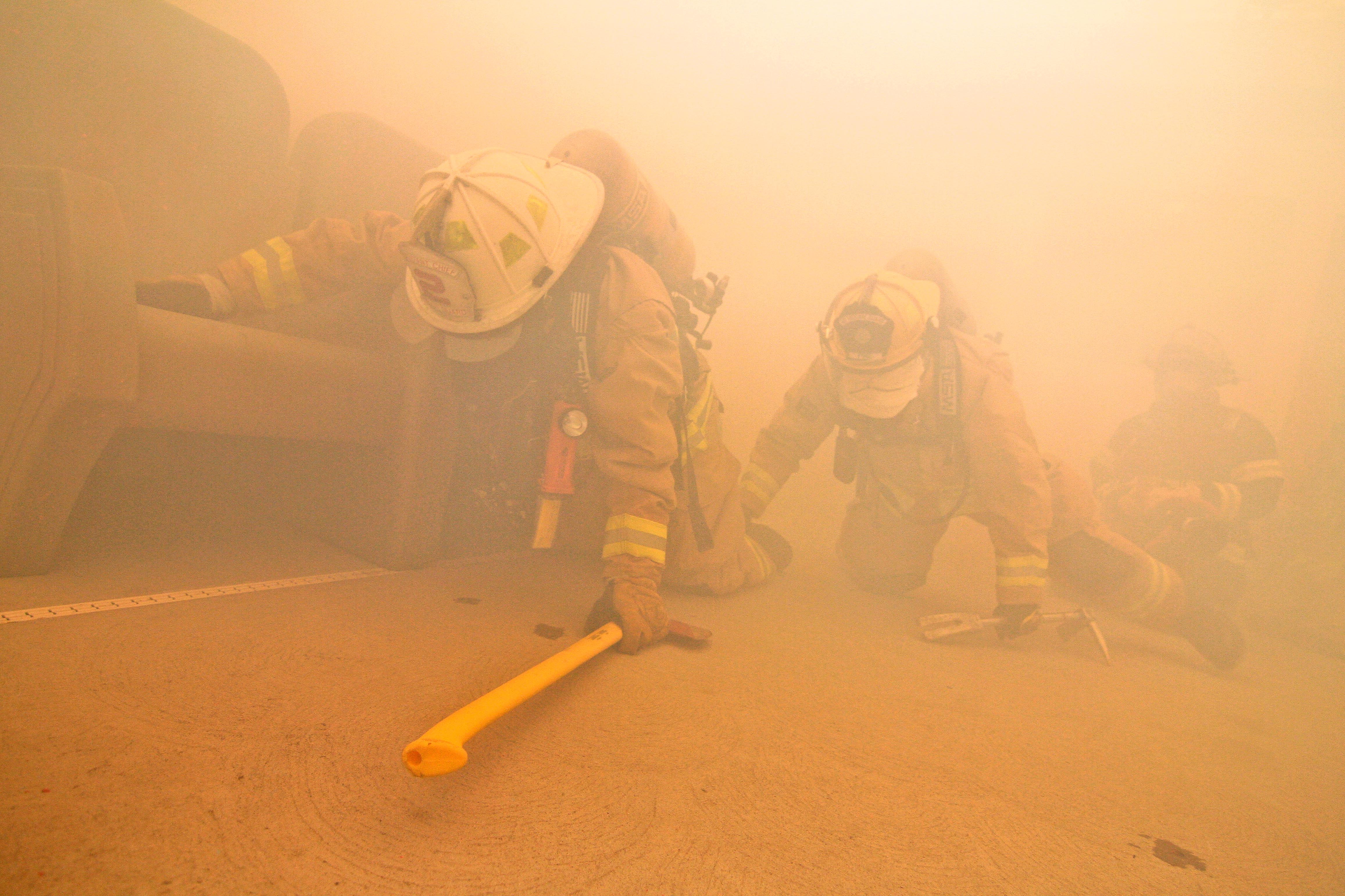 Air Force Fire Protection Specialists Perform A Search In A