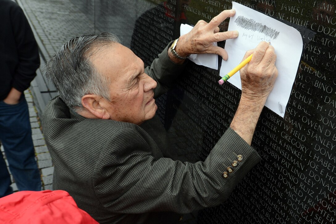Medal of Honor recipient Army Master Sgt. Jose Rodela stencils a friend’s name from the Vietnam Veterans Memorial in Washington, D.C., March 19, 2014. Rodela toured the memorial with his family, Medal of Honor recipient Army Sgt. Santiago J. Erevia, and others who accepted Medals of Honor on behalf of a family member a day earlier.