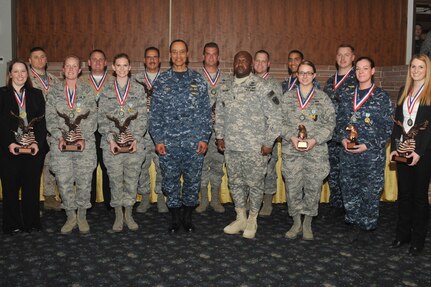 OFFUTT AIR FORCE BASE, Neb. (March 21, 2014) Commander, U.S. Strategic Command (USSTRATCOM) Adm. Cecil D. Haney and USSTRATCOM Senior Enlisted Leader Cmd. Sgt. Maj. Patrick Z. Alston, center, stand with the 2013 USSTRATCOM Annual Awards recipients at the Patriot Club on Offutt Air Force Base. The awards ceremony highlighted USSTRATCOM's top military and civilian performers assigned to the command's headquarters, functional components, and task forces. (U.S. Air Force photo by Steve Cunningham/Released)