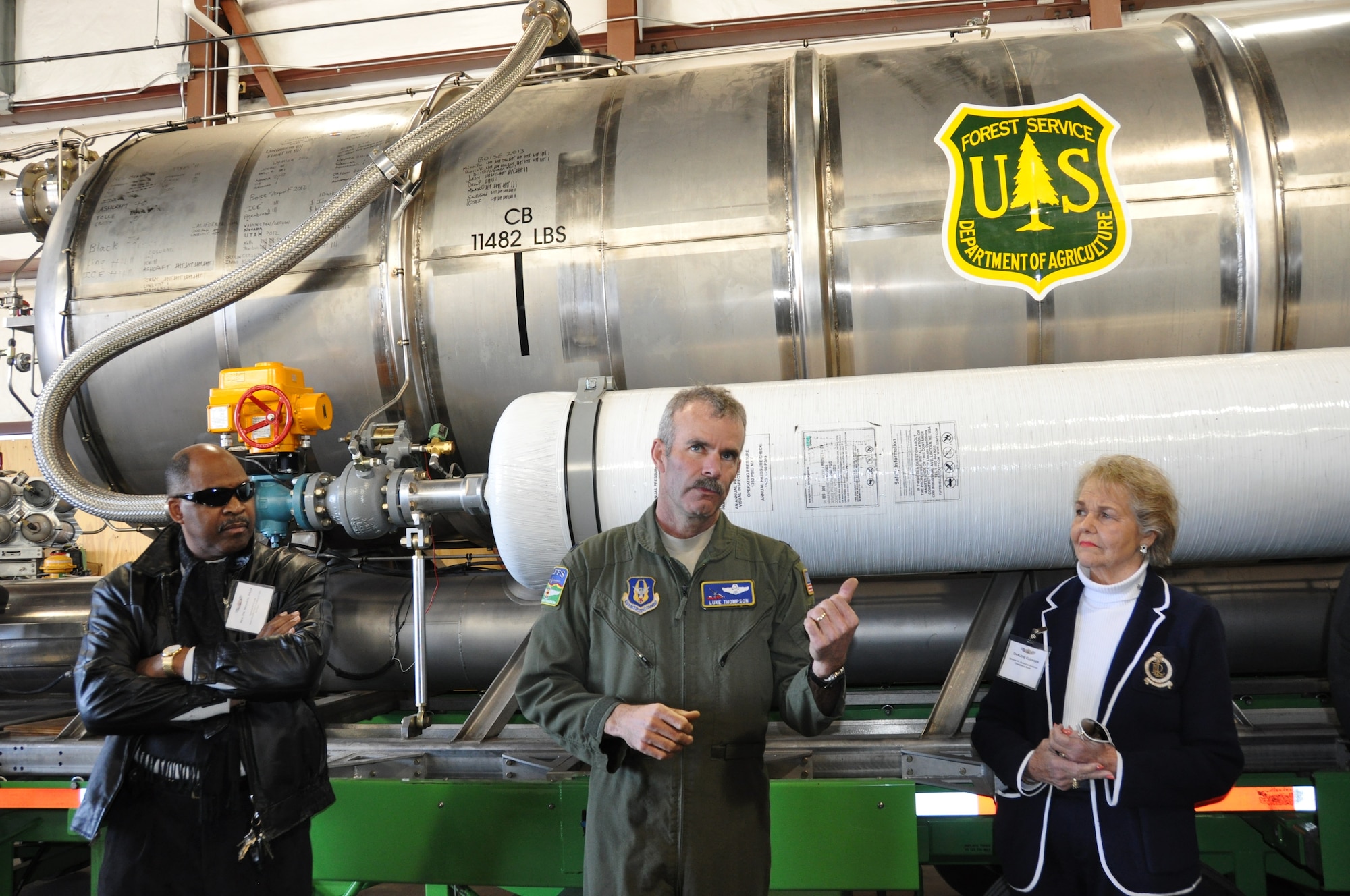Lt. Col. Luke Thompson, a 731st Airlift Squadron pilot,  explains the capabilities of the Modular Aerial Firefighting System to Rev. Dr. Michael Jolla (left) of the West End Baptist Church, and Darlene Gleinser of Comerica Bank, during the 433rd Airlift Wing's Civic Leader's tour to the 302nd Airlift Wing on Peterson Air Force Base, Colo. March 20, 2014. Lt. Col. Thompson has over 9,000 hours flying the C-130 Hercules H model fighting fires on the West Coast and in Mexico.(U.S. Air Force photo by Tech Sgt. Carlos J. Trevino