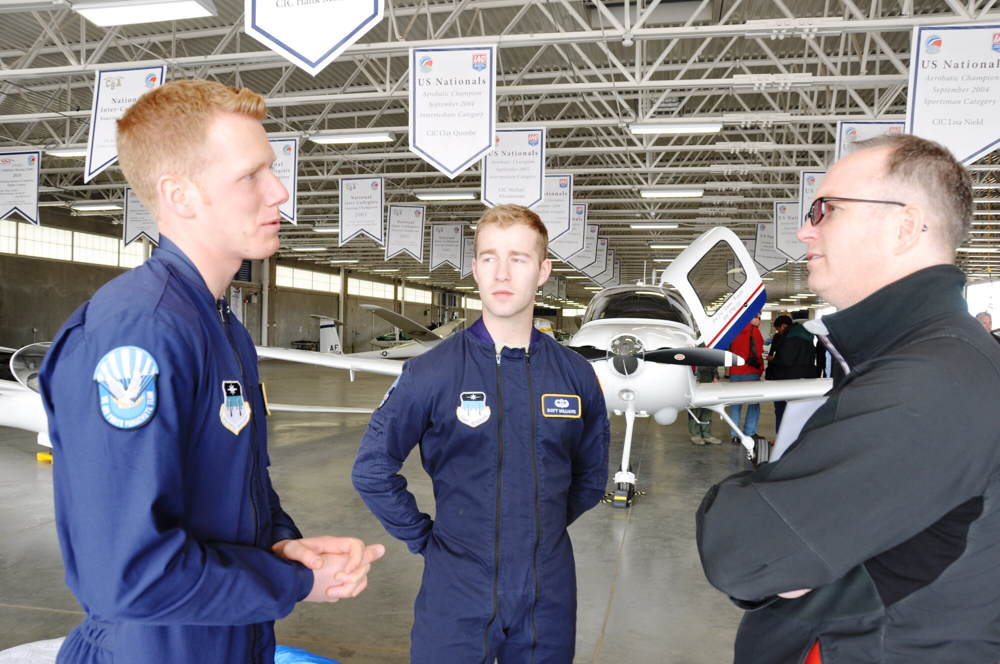 U.S. Air Force Academy cadets Isaac Rydman and Matt Williams talk with Clay Richmond, President, Pizza Hut of San Antonio No. 11, Inc.,  during the 433rd Airlift Wing’s Civic Leader Tour to Colorado Springs, Colo. on March 21, 2014, about their duties as jump masters. The cadets teach other cadets how to parachute. (U.S. Air Force photo by Tech Sgt. Carlos J. Trevino)