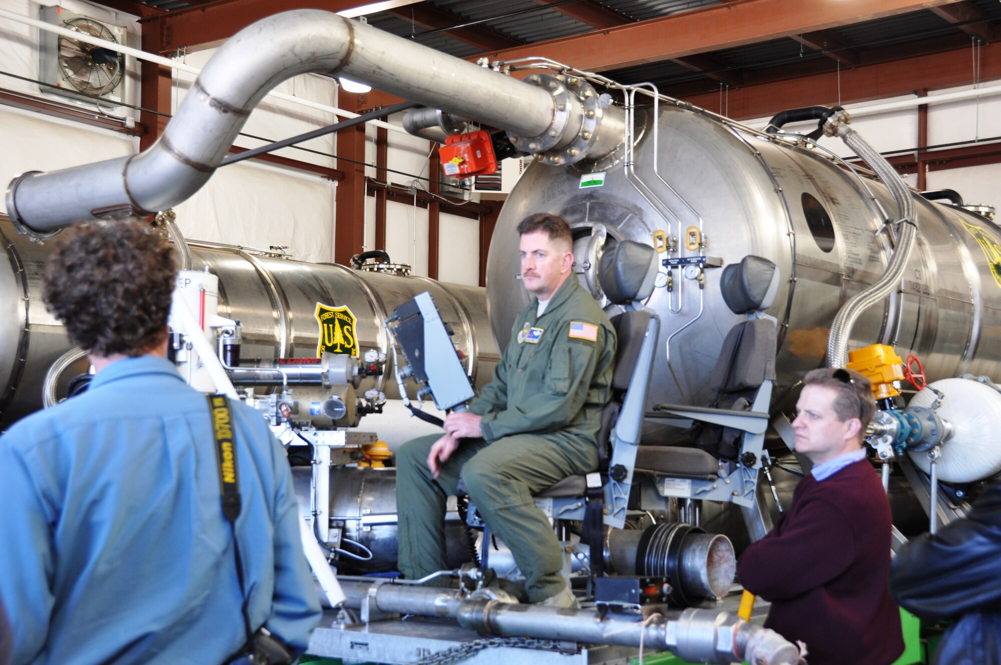 Master Sgt. Sean Stephens, a 52nd Airlift Squadron loadmaster and Modular Aerial Firefighting System operator, sits at the controls of the MAFFS, and explains it use and capabilities on March 21, 2014, to the 433rd Airlift Wing’s Civic Leaders Tour at Peterson Air Force Base, Colo. The MAFFS is loaded aboard a C-130H Hercules to fight fires when it is called upon by the U.S. Forest Service. The 302nd Airlift Wing is the only Air Force Reserve unit with this mission. (U.S. Air Force photo by Tech Sgt. Carlos J. Trevino) 