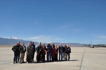 In the shadow of Pike's Peak, the 433rd Airlift Wing's Civic Leaders' Tour group gathers on the tarmac at Peterson Air Force Base, Colo. as a C-130H Hercules from the 731st Airlift Squadron prepares to go on an Modular Aerial Firefighting System training mission on March 20, 2014. (U.S. Air Force photo by Tech Sgt. Carlos J. Trevino) 
