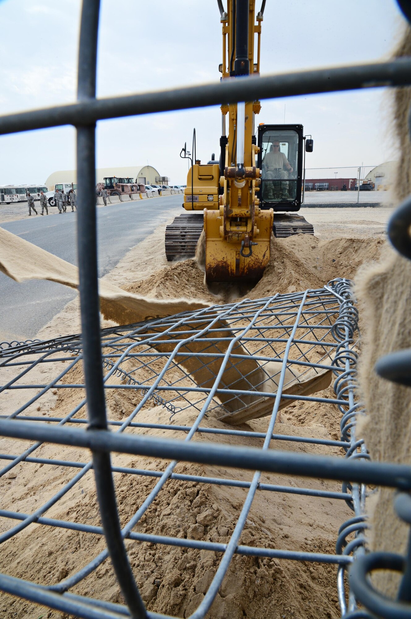 Senior Airman William Wood, 386th Expeditionary Civil Engineer Squadron heavy equipment, removes a HESCO bunker with an excavator, at an undisclosed location in Southwest Asia. The bunker was causing a driving hazard for the CE large vehicle yard. Woods is deployed with the Utah Air National Guard and is a Layton, Utah, native. (U.S. Air Force photo by Senior Airman Desiree W. Moye)