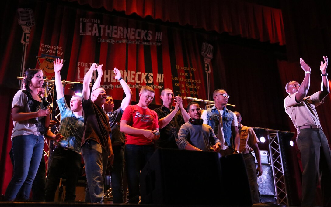 Marines and sailors aboard the Combat Center enjoy music and dance prior to the Leatherneck Comedy Tour show at the base theater, March 14, 2014. The show featured comedians Byron Bowers, Jim McCue and Ben Gleib, as well as a musical performance by Eve 6.