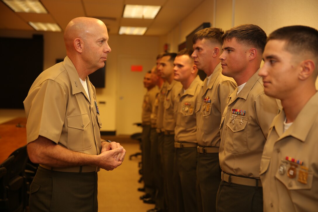 Maj. Gen. David H Berger, Combat Center commanding general, speaks with each MCAGCC shooting team Marine during their trophy presentation at the commanding general’s conference room, March 14, 2014. The team was comprised of eight enlisted Maries and three officers.