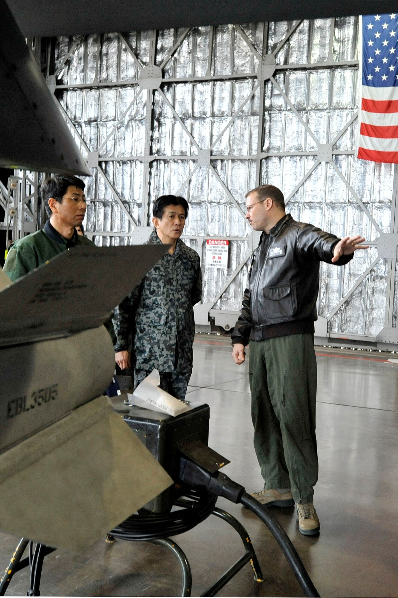 MISAWA AIR BASE, Japan -- Japan Air Self-Defense Force Maj. Gens. Tomoyuki Ueda, Northern Air Defense Force vice commander and Shigeki Nakahara, Northern Aircraft Control and Warning Wing commander, tour an F-16 Fighting Falcon with Col. Stephan Williams, 35th Fighter Wing commander, in Hangar 911, March 18, 2014. The tour exemplifies Pacific Air Force’s joint mission requirements: expanding engagements and strengthening relationships with allies and partners while expanding outreach. (U.S. Air Force photo/Staff Sgt. Tong Duong)