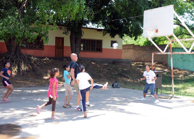 Members of Joint Task Force-Bravo's Medical Element provided some bliss for local children during an orphanage visit in Comayagua, Honduras March 22, 2014.  More than 25 members made the trip to the Hogar de Ninos, Nazareth girls orphanage where they spent a Saturday afternoon visiting with more than 50 children.  They braided the girl's hair, painted their fingernails, played soccer, read books and drew pictures with the kids.  (Photo by U. S. Air National Guard Capt. Steven Stubbs)