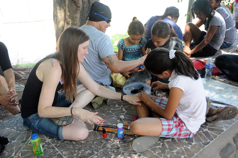 Members of Joint Task Force-Bravo's Medical Element provided some bliss for local children during an orphanage visit in Comayagua, Honduras March 22, 2014.  More than 25 members made the trip to the Hogar de Ninos, Nazareth girls orphanage where they spent a Saturday afternoon visiting with more than 50 children.  They braided the girl's hair, painted their fingernails, played soccer, read books and drew pictures with the kids.  (Photo by U. S. Air National Guard Capt. Steven Stubbs)