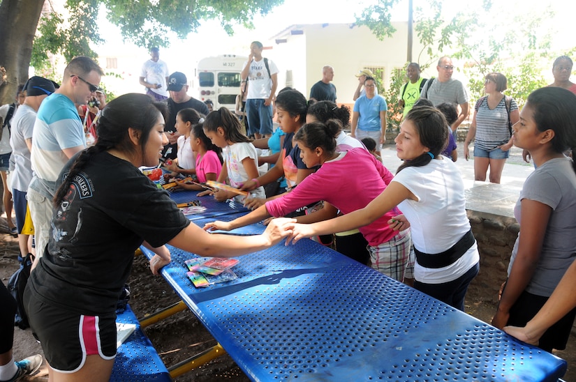 Members of Joint Task Force-Bravo's Medical Element provided some bliss for local children during an orphanage visit in Comayagua, Honduras March 22, 2014.  More than 25 members made the trip to the Hogar de Ninos, Nazareth girls orphanage where they spent a Saturday afternoon visiting with more than 50 children.  They braided the girl's hair, painted their fingernails, played soccer, read books and drew pictures with the kids.  (Photo by U. S. Air National Guard Capt. Steven Stubbs)