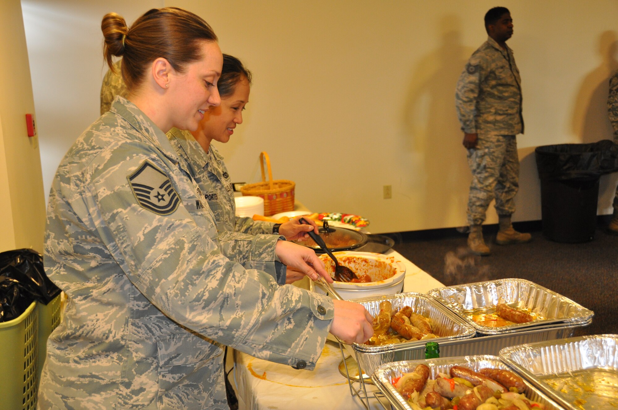 Members of the 514th Civil Engineering Squadron serve attendees at the Super Sandwich Saturday event held here March 22. The event was sponsored by the squadron's morale, welfare and recreation council in which members were treated to sausage and pepper subs, meatball subs, ice cream, music and card games (U.S. Air Force photo/Senior Airman Chelsea Smith).