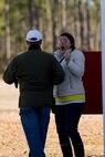 A spouse with 2nd Dental Battalion, 2nd Marine Logistics Group, II Marine Expeditionary Force reacts after hitting a clay pigeon on her first attempt during a spouse meet and greet at the McIntyre Shooting Complex aboard Camp Lejeune, N.C., March 21, 2014. The battalion hosted the skeet shooting and archery event to help build connections among its service member’s families. (U.S. Marine Corps photo by Lance Cpl. Shawn Valosin)