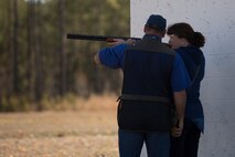 A spouse with 2nd Dental Battalion, 2nd Marine Logistics Group, II Marine Expeditionary Force, receives instructions from a shooting coach at the McIntyre Shooting Complex aboard Camp Lejeune, N.C., March 21, 2014. The battalion hosted the skeet shooting and archery event to help build connections among its service member’s families. (U.S. Marine Corps photo by Lance Cpl. Shawn Valosin)