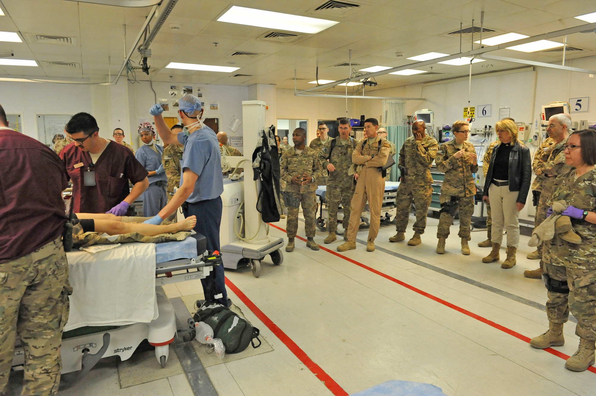 Deborah Lee James, Secretary of the Air Force, watches an exercise in the emergency room of the Craig Joint Theater Hospital, Bagram Airfield, Afghanistan, while being briefed about the process by Maj. Sarah Abel, March 22, 2014. CJTH is a Role III trauma center with full emergency and operating room capabilities.(U.S. Air Force photo by Senior Master Sgt. Gary J. Rihn)