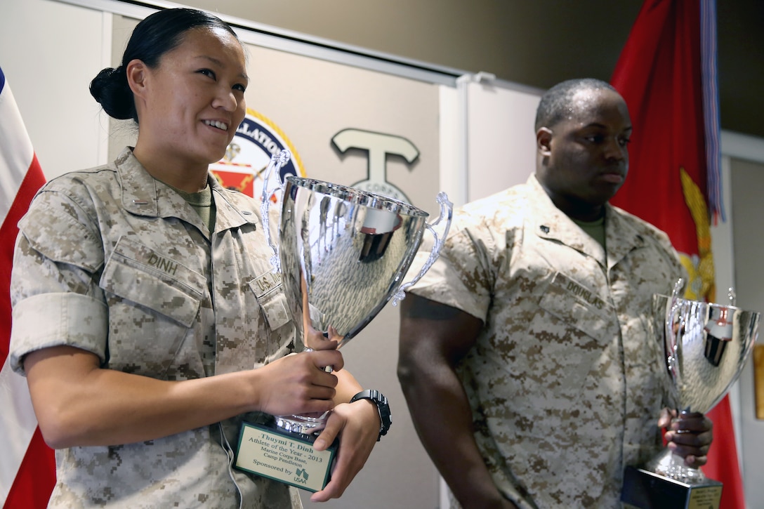1st Lt. Thuymi Dinh and Sgt. David Douglas were awarded the Female and Male Athlete of the Year Awards March 20 in the Commanding General's conference room. Dinh was awarded for her success in various races and triathlons and Douglas was awarded for his success in powerlifting competitions. The awards were presented by Brig. Gen. John W. Bullard, the commanding general of Marine Corps Installations West-Marine Corps Base Camp Pendleton.